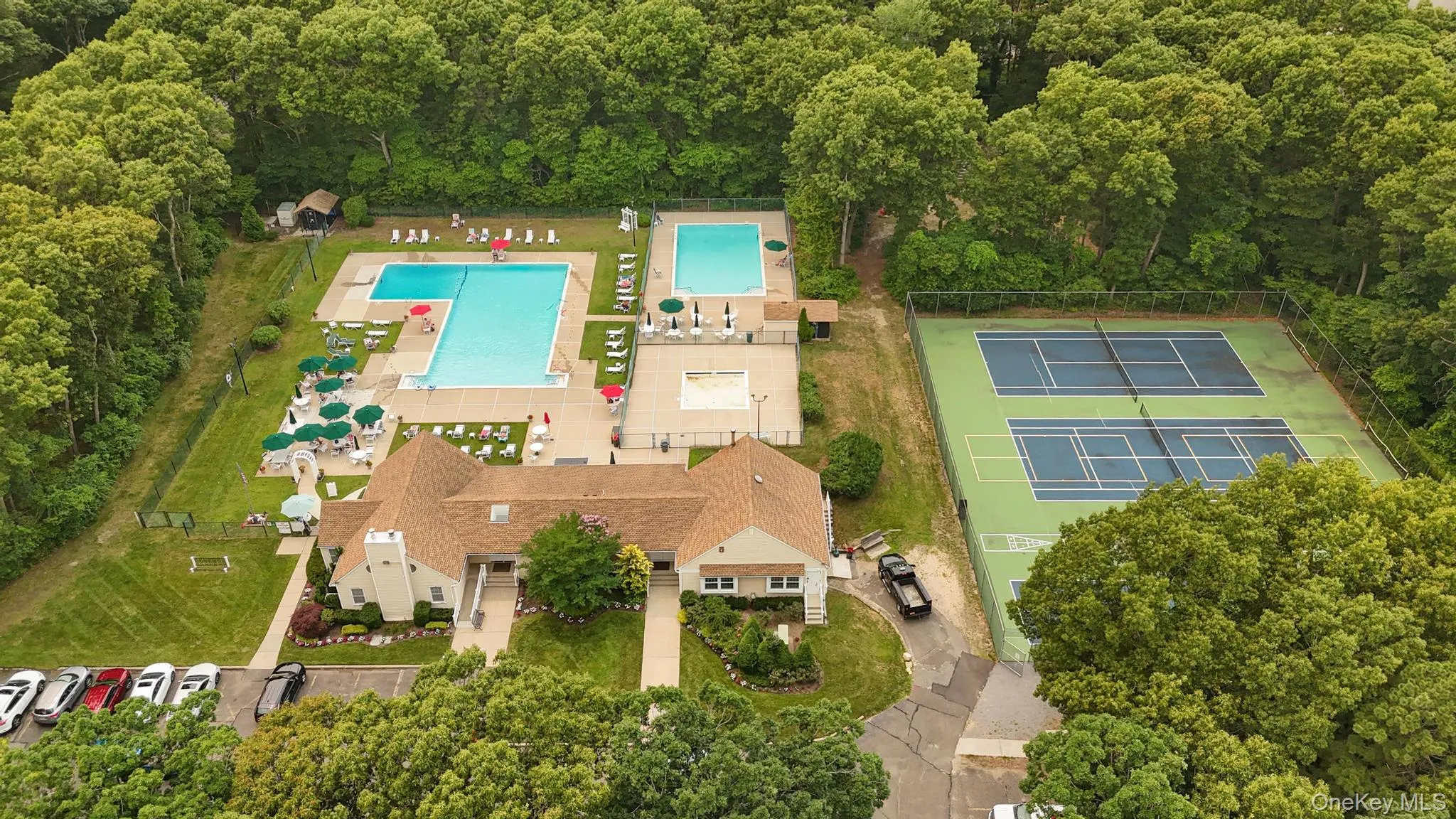 Clubhouse with pool and tennis/pickleball courts Clubhouse with pool and tennis/pickleball courts