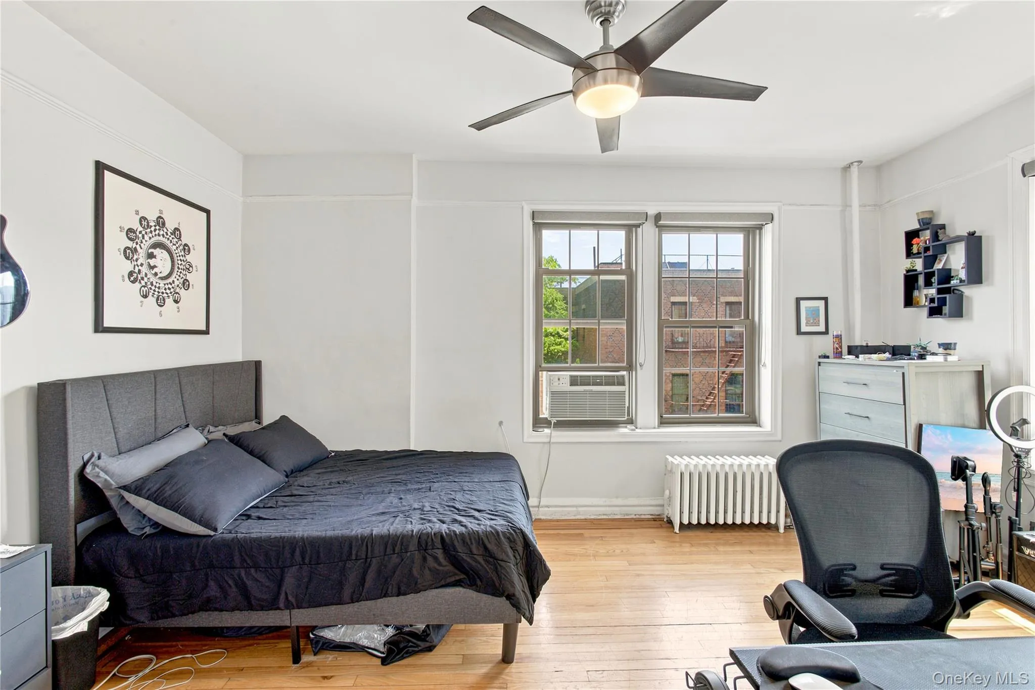 Hardwood flooring and multiple windows illuminate this room Hardwood flooring and multiple windows illuminate this room