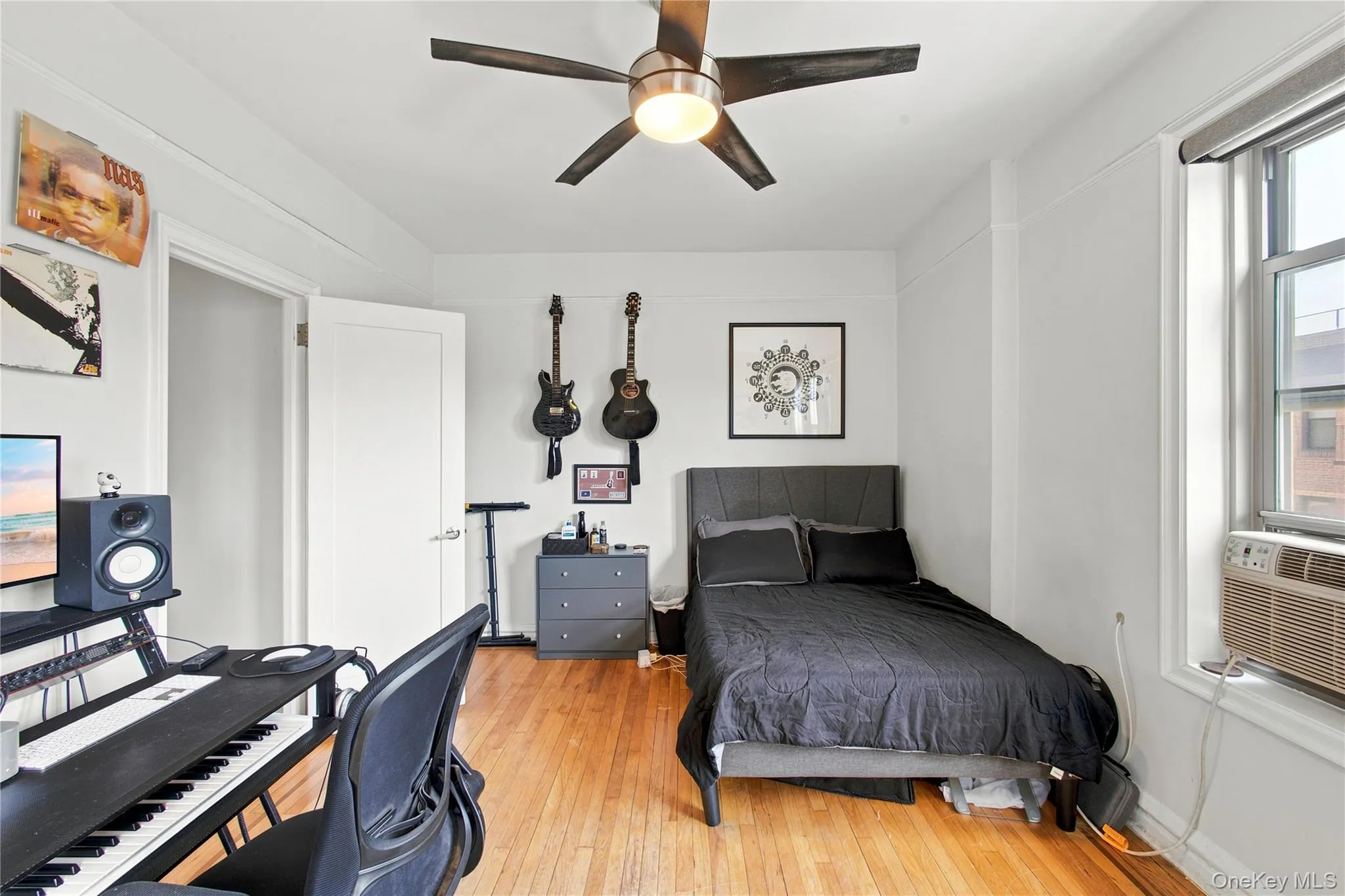 Main Bedroom featuring wood-finish flooring and white painted walls Main Bedroom featuring wood-finish flooring and white painted walls