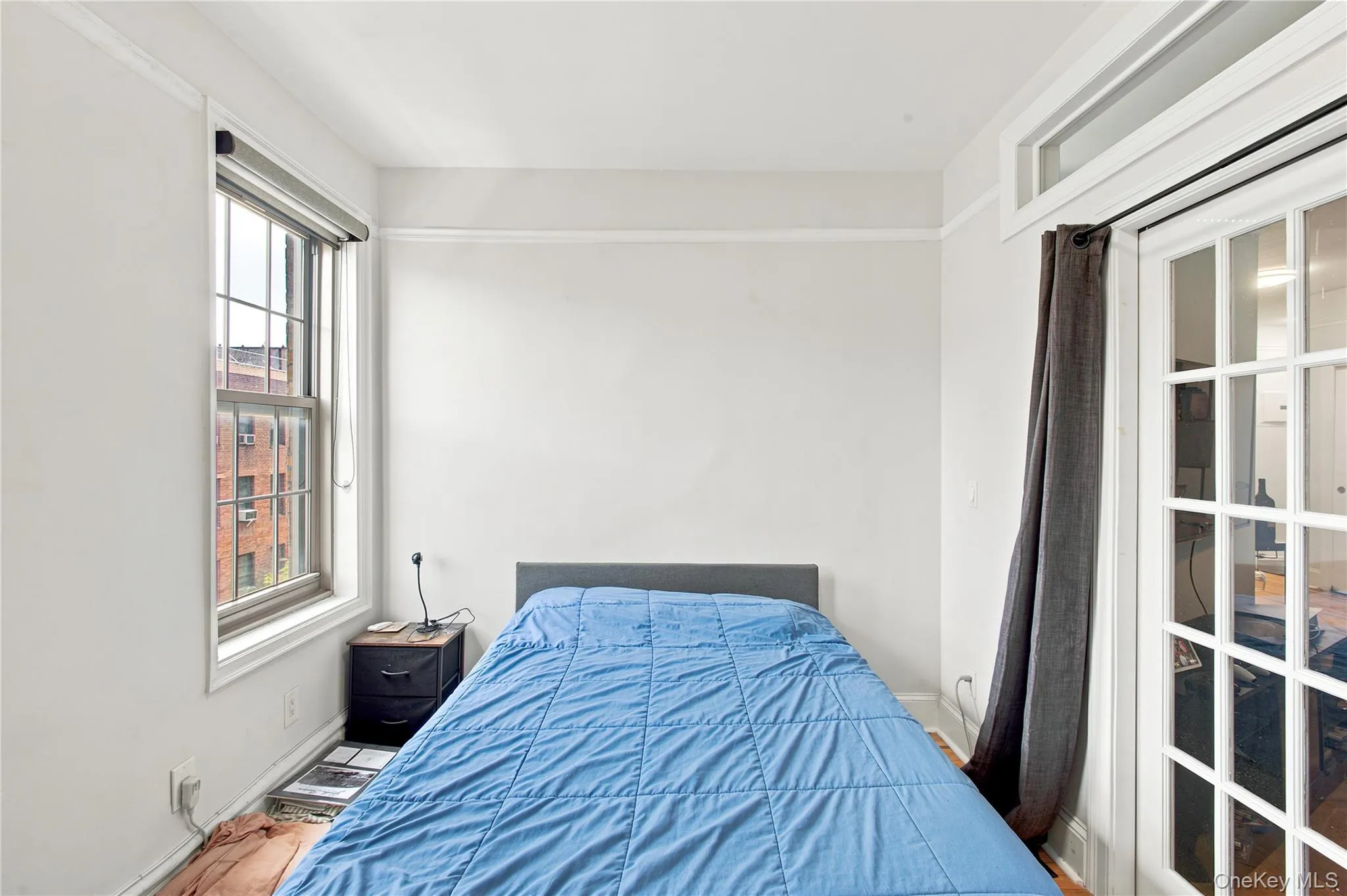 2nd Bedroom featuring a large window with gridded panes, French doors with transom window, and crown molding 2nd Bedroom featuring a large window with gridded panes, French doors with transom window, and crown molding