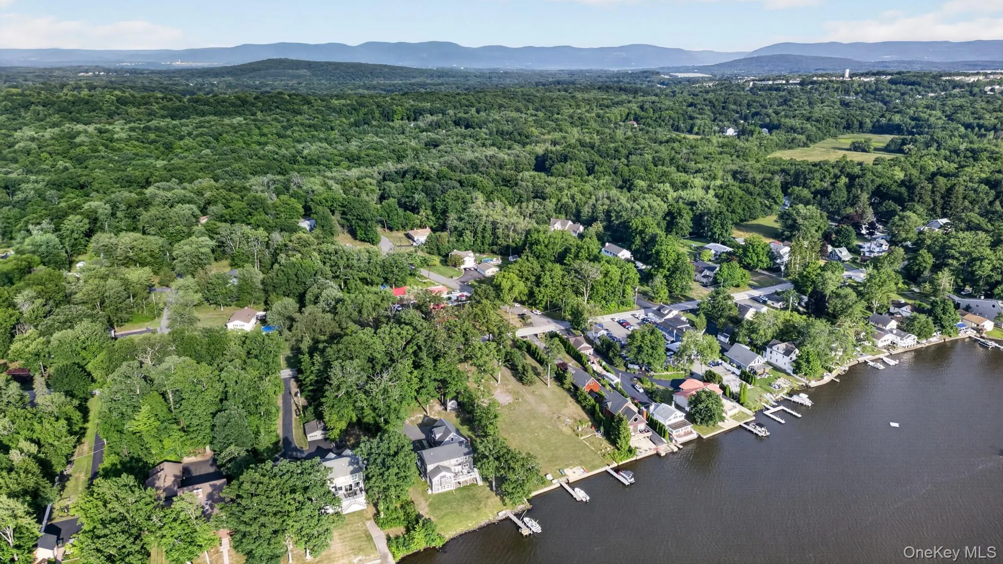 Aerial perspective showcasing a waterfront community with numerous properties featuring private docks Aerial perspective showcasing a waterfront community with numerous properties featuring private docks