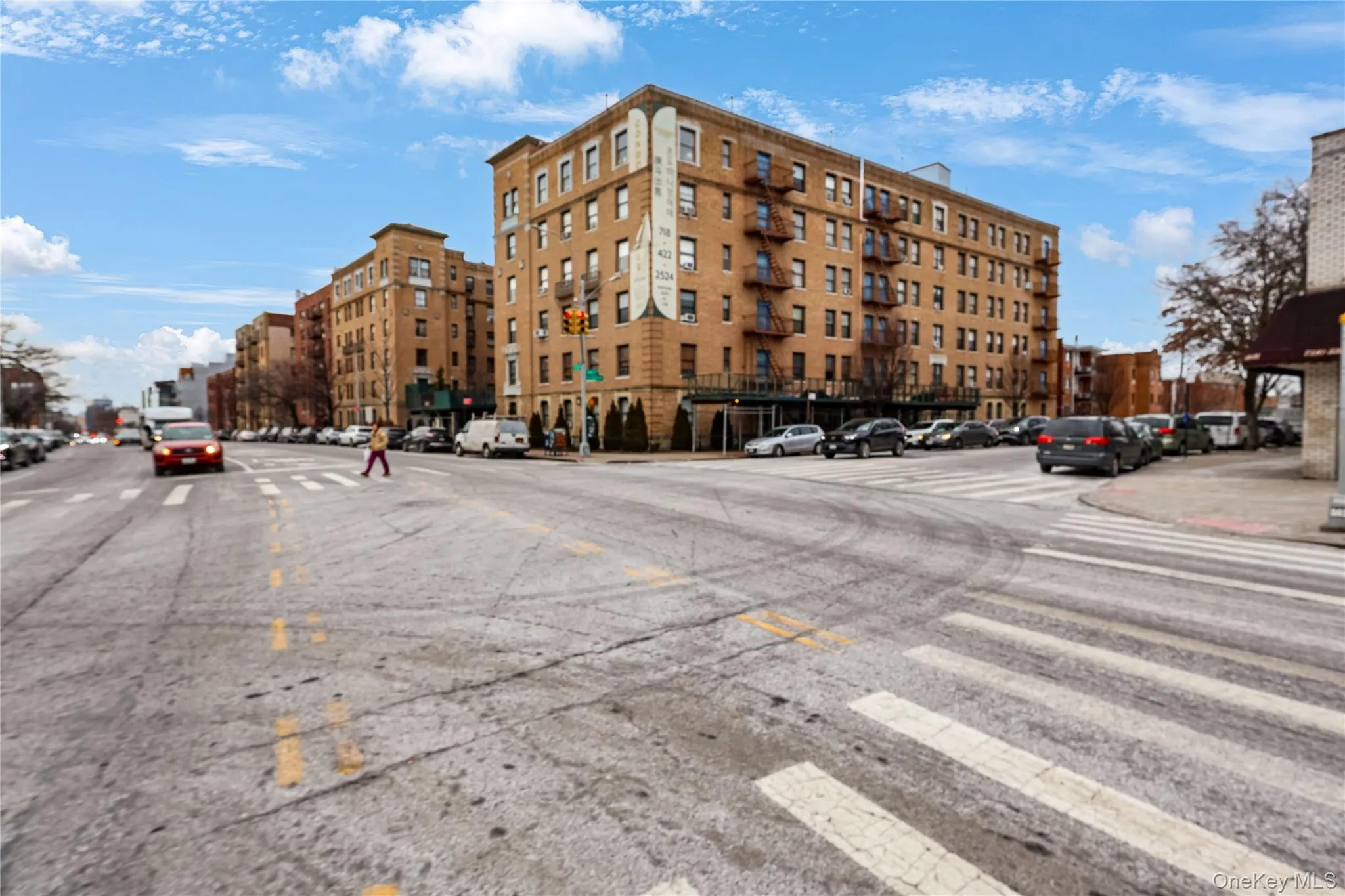 Multi-story brick building with fire escapes and multiple windows Multi-story brick building with fire escapes and multiple windows