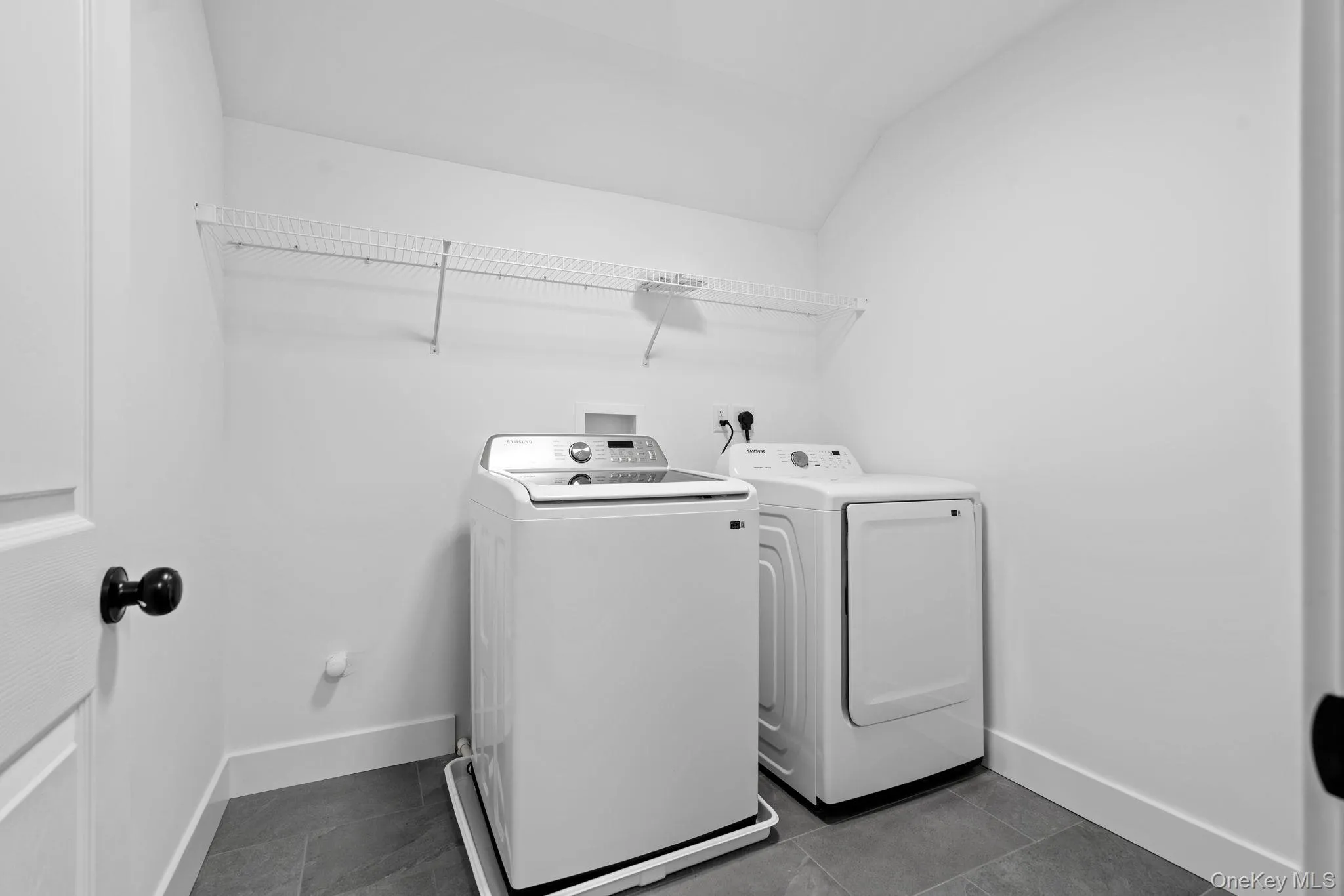 Washroom with independent washer and dryer, laundry area, and baseboards Washroom with independent washer and dryer, laundry area, and baseboards