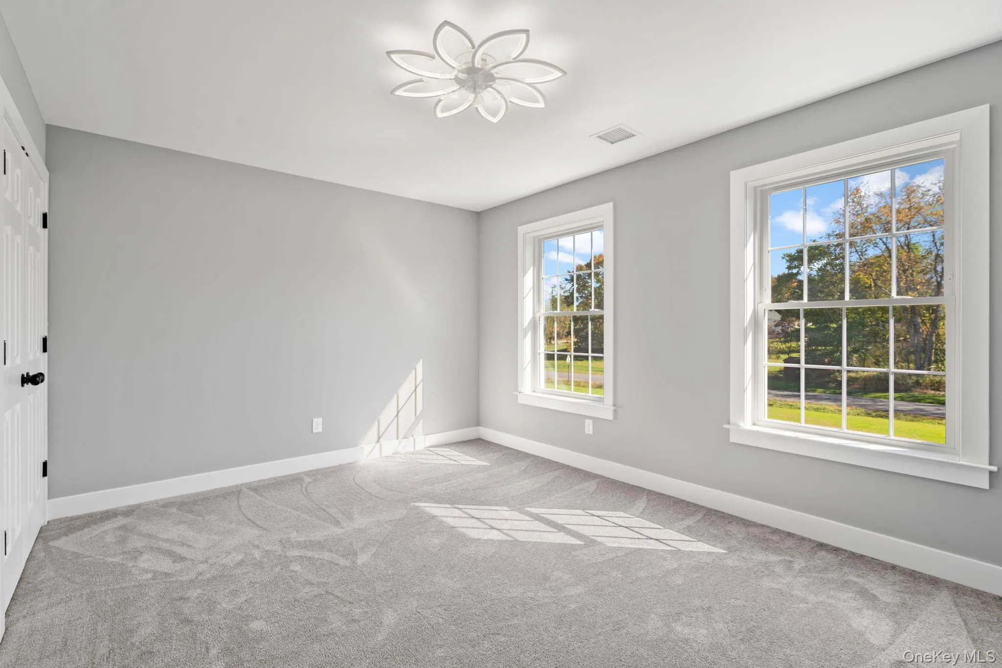 Empty room featuring carpet, visible vents, and baseboards Empty room featuring carpet, visible vents, and baseboards