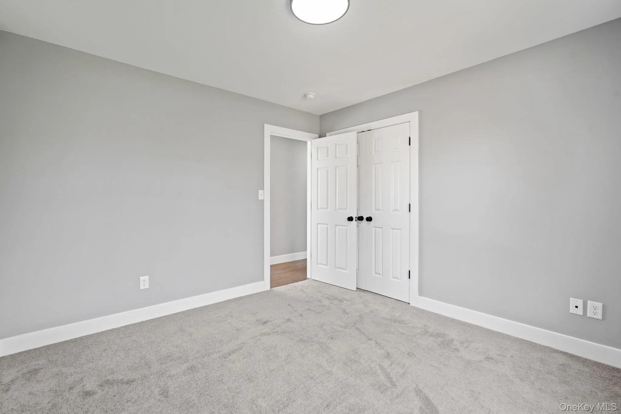 Unfurnished bedroom featuring a closet, baseboards, and carpet floors Unfurnished bedroom featuring a closet, baseboards, and carpet floors