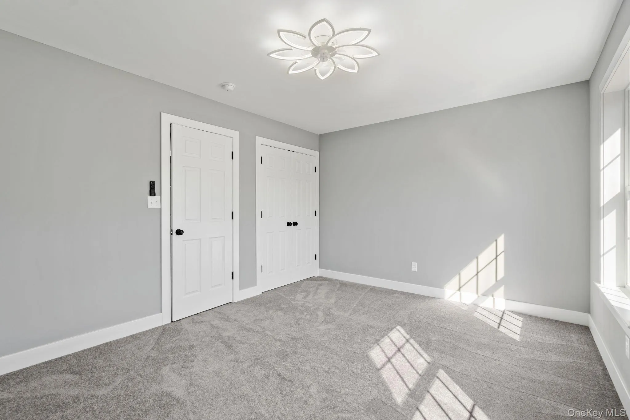 Unfurnished bedroom with baseboards and carpet flooring Unfurnished bedroom with baseboards and carpet flooring