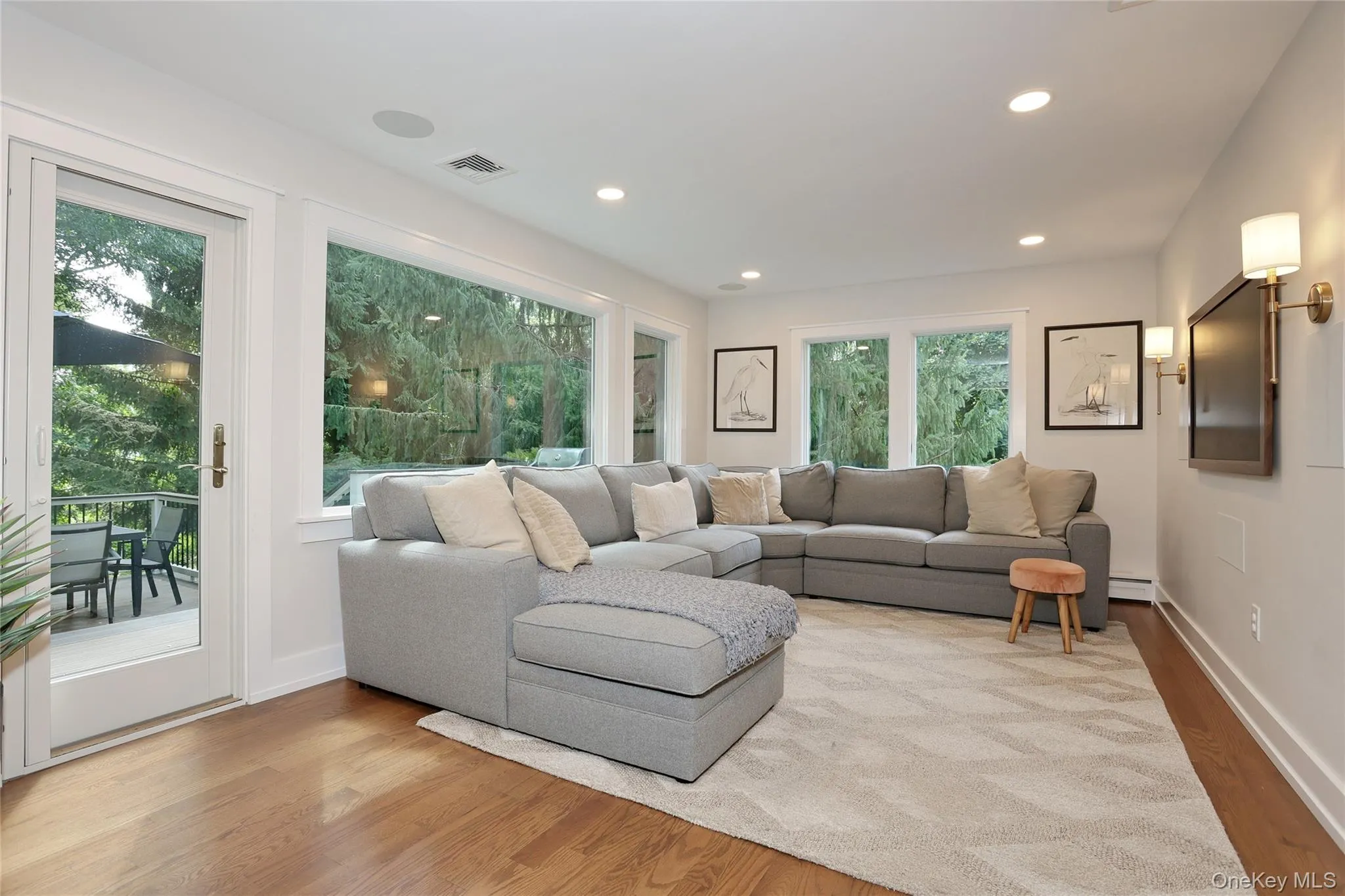 Expansive windows and glass door to the deck frame the surrounding landscape. Expansive windows and glass door to the deck frame the surrounding landscape.