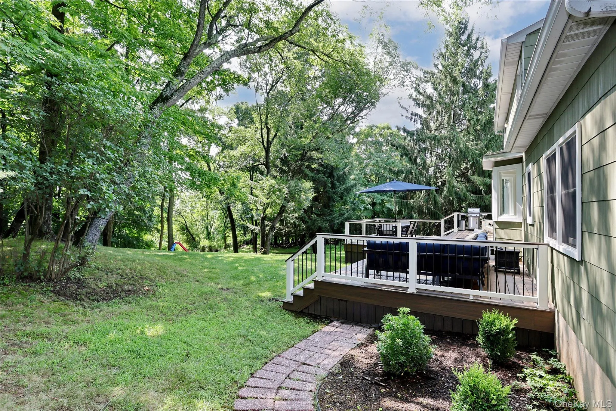View of the garden and trex deck. View of the garden and trex deck.
