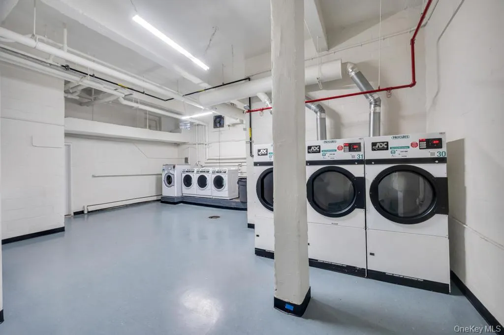 On-site laundry room featuring multiple commercial-grade washers and dryers On-site laundry room featuring multiple commercial-grade washers and dryers