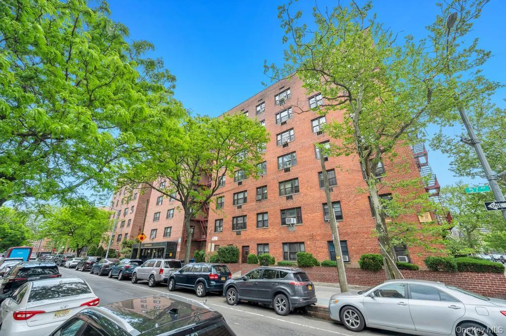 Brick exterior building featuring multiple levels and numerous windows Brick exterior building featuring multiple levels and numerous windows