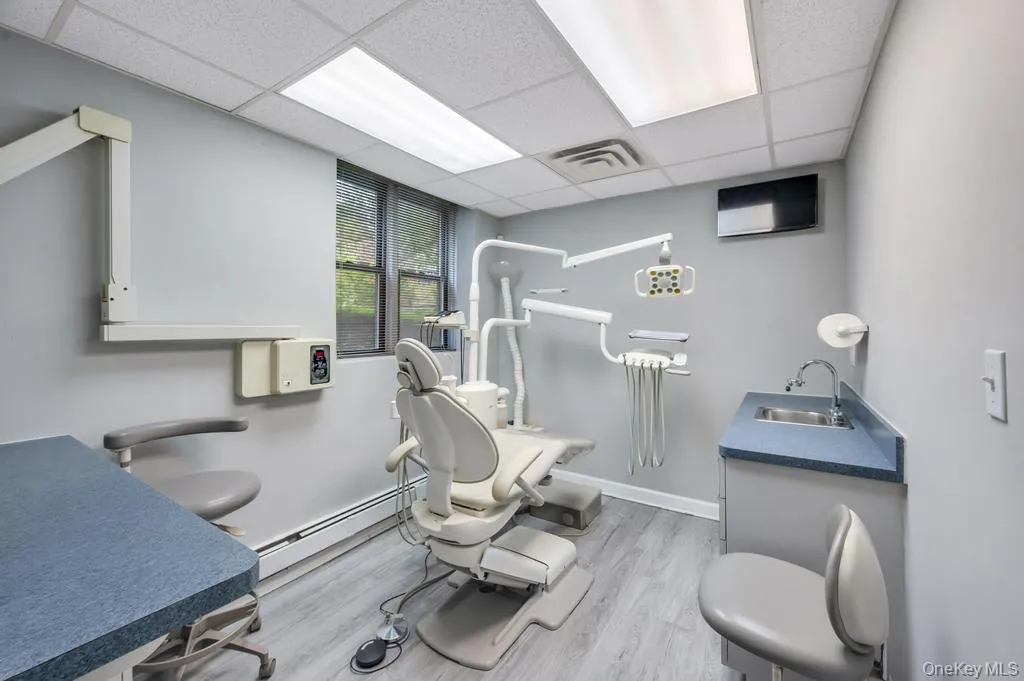 Dedicated clinical space featuring recessed lighting, paneled ceilings, and wood-finish flooring Dedicated clinical space featuring recessed lighting, paneled ceilings, and wood-finish flooring