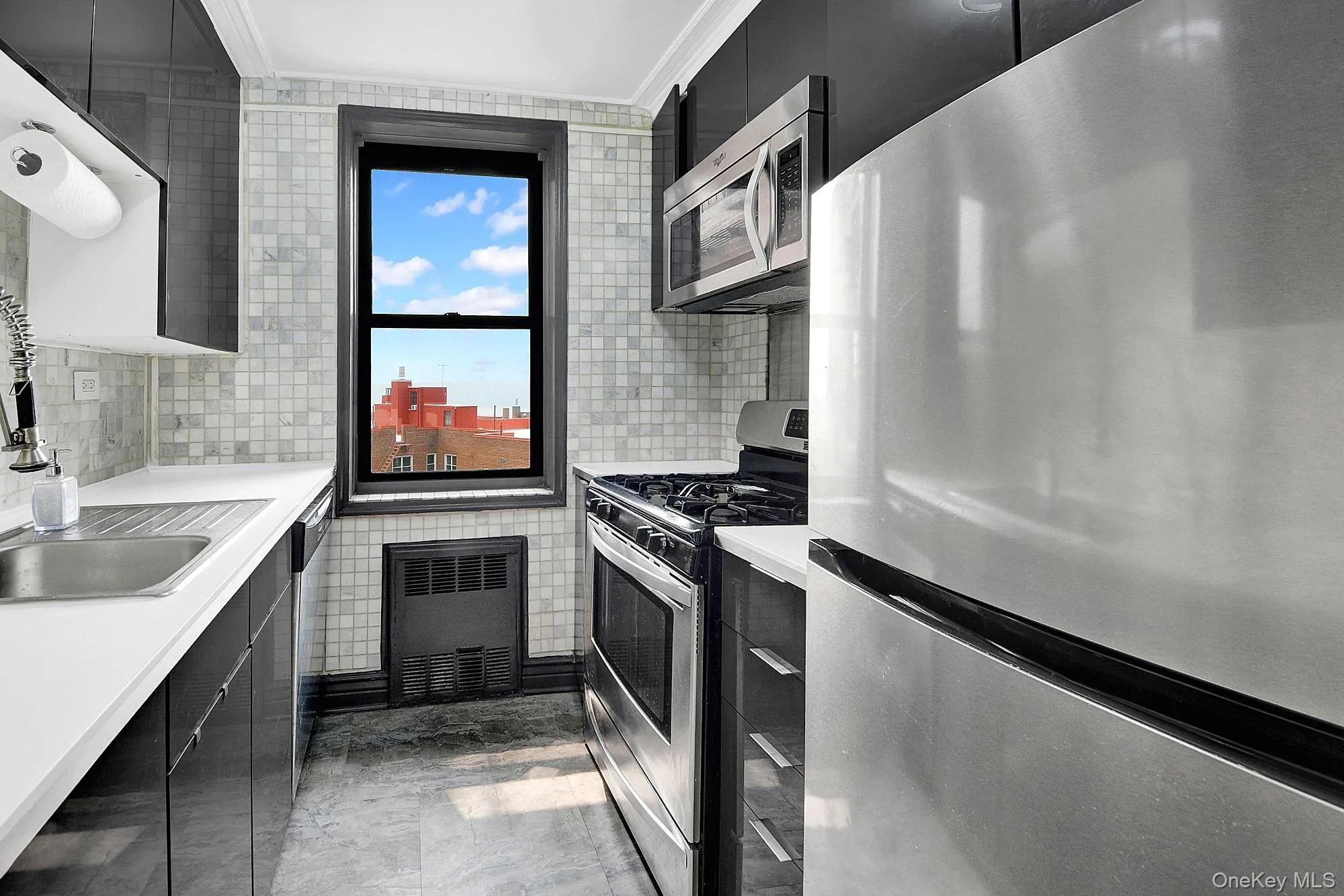 Updated windowed galley kitchen with stainless steel appliances. Updated windowed galley kitchen with stainless steel appliances.