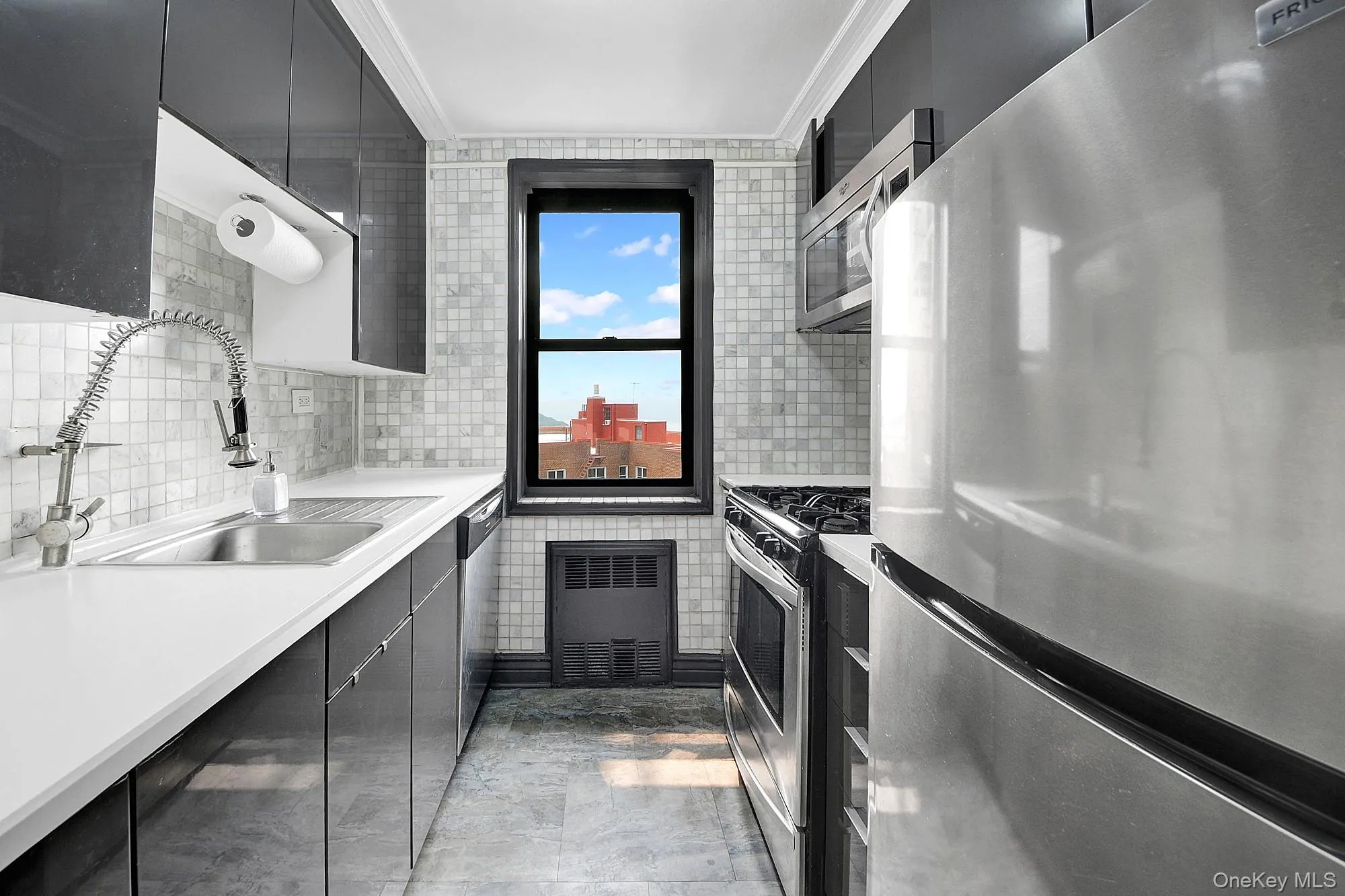 Updated windowed galley kitchen with stainless steel appliances. Updated windowed galley kitchen with stainless steel appliances.