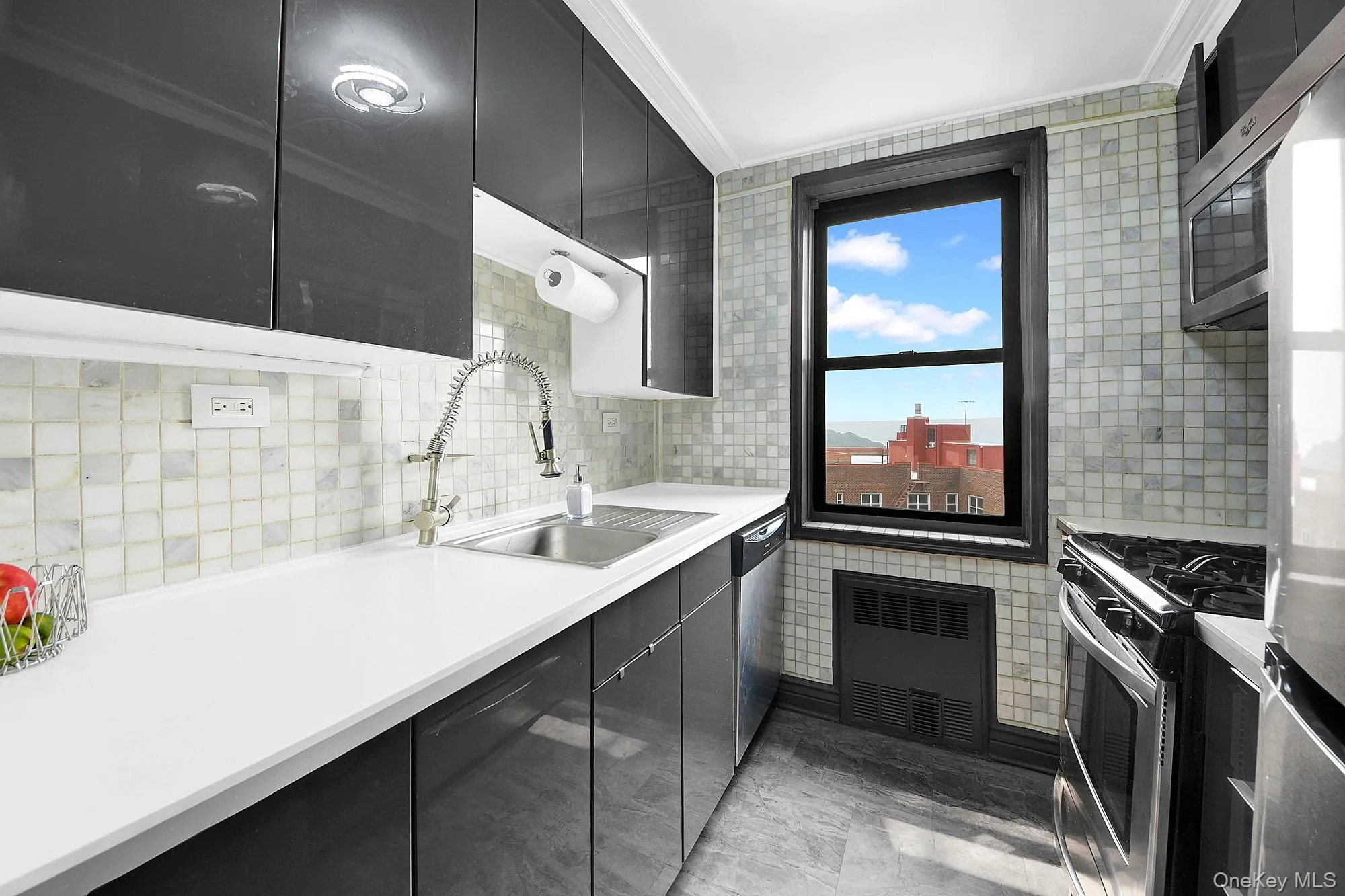 Updated windowed galley kitchen with stainless steel appliances. Updated windowed galley kitchen with stainless steel appliances.