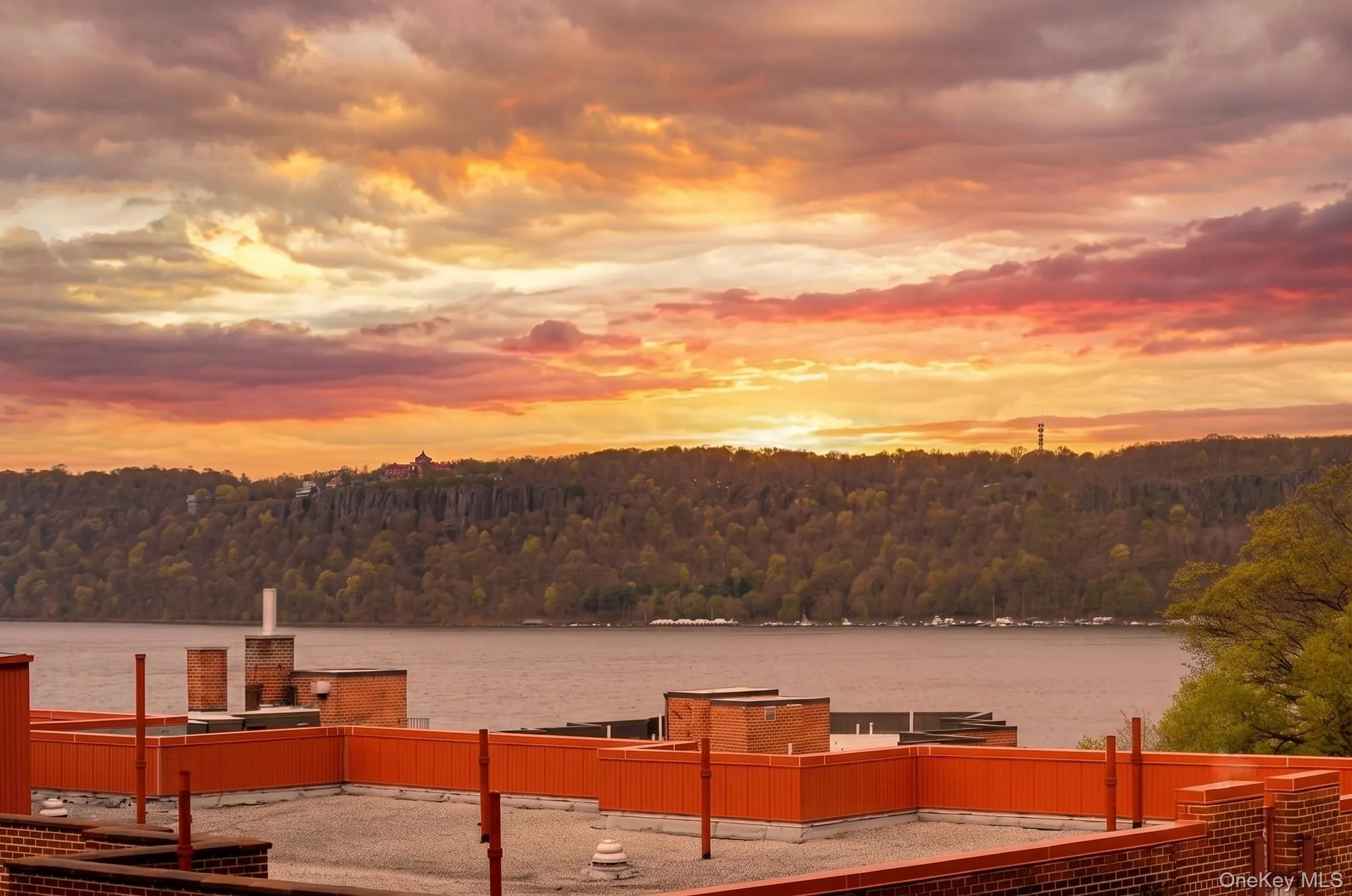 Beautiful view with Hudson River visible over the roof tops. Beautiful view with Hudson River visible over the roof tops.