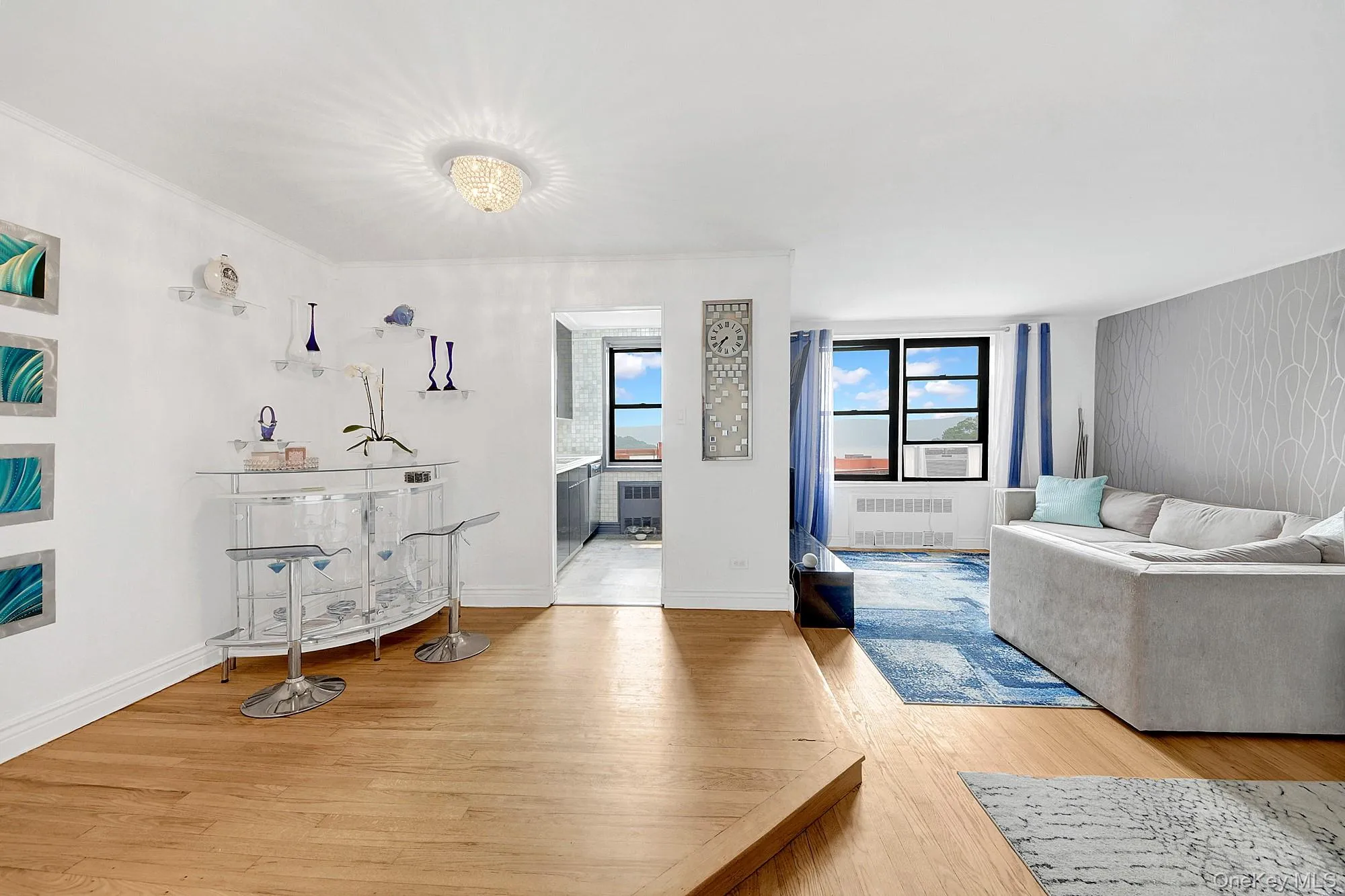 Large and open living room with an elevated dining area that leads to the kitchen. Hardwood floors throughout. Large and open living room with an elevated dining area that leads to the kitchen. Hardwood floors throughout.