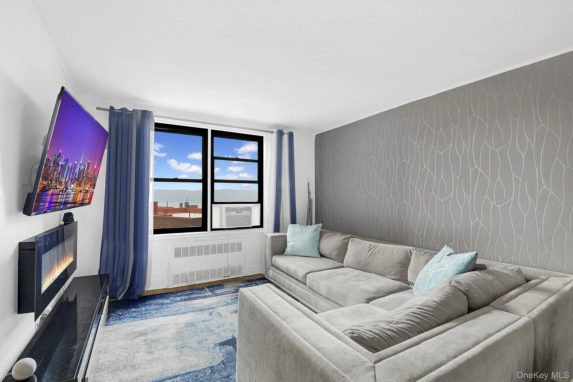 Large living room with double windows and hardwood floors. Large living room with double windows and hardwood floors.