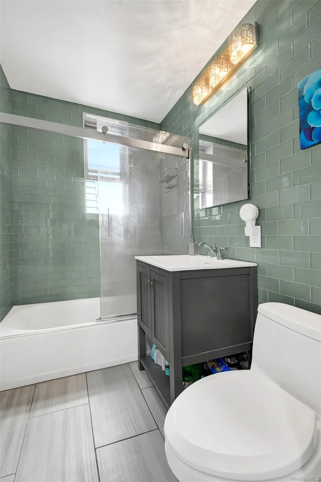 Updated windowed bathroom with glass subway tiles, soaking tub and updated fixtures. Updated windowed bathroom with glass subway tiles, soaking tub and updated fixtures.