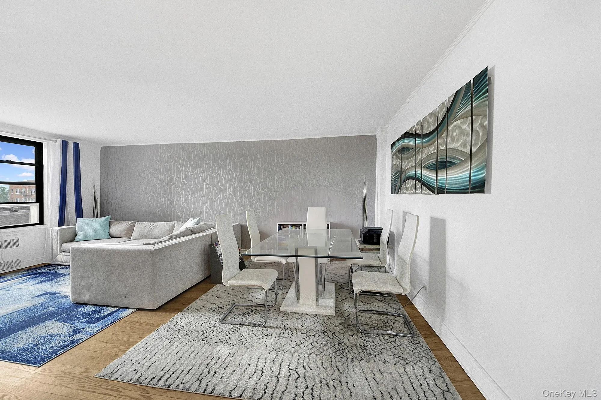 Large living room with double windows and hardwood floors. Large living room with double windows and hardwood floors.