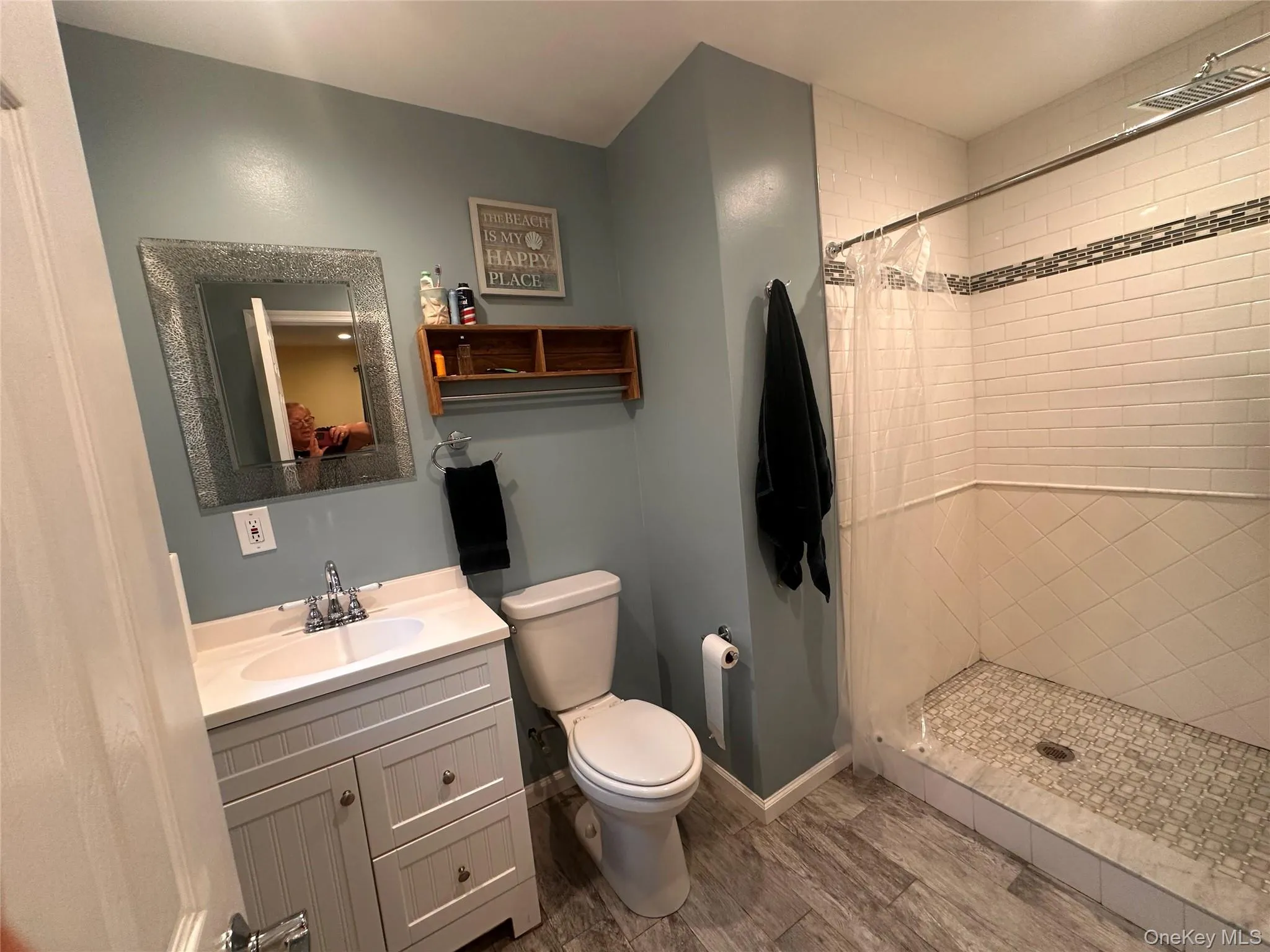 Bathroom features a walk-in shower with subway tile, and a decorative tile shower floor. Bathroom features a walk-in shower with subway tile, and a decorative tile shower floor.