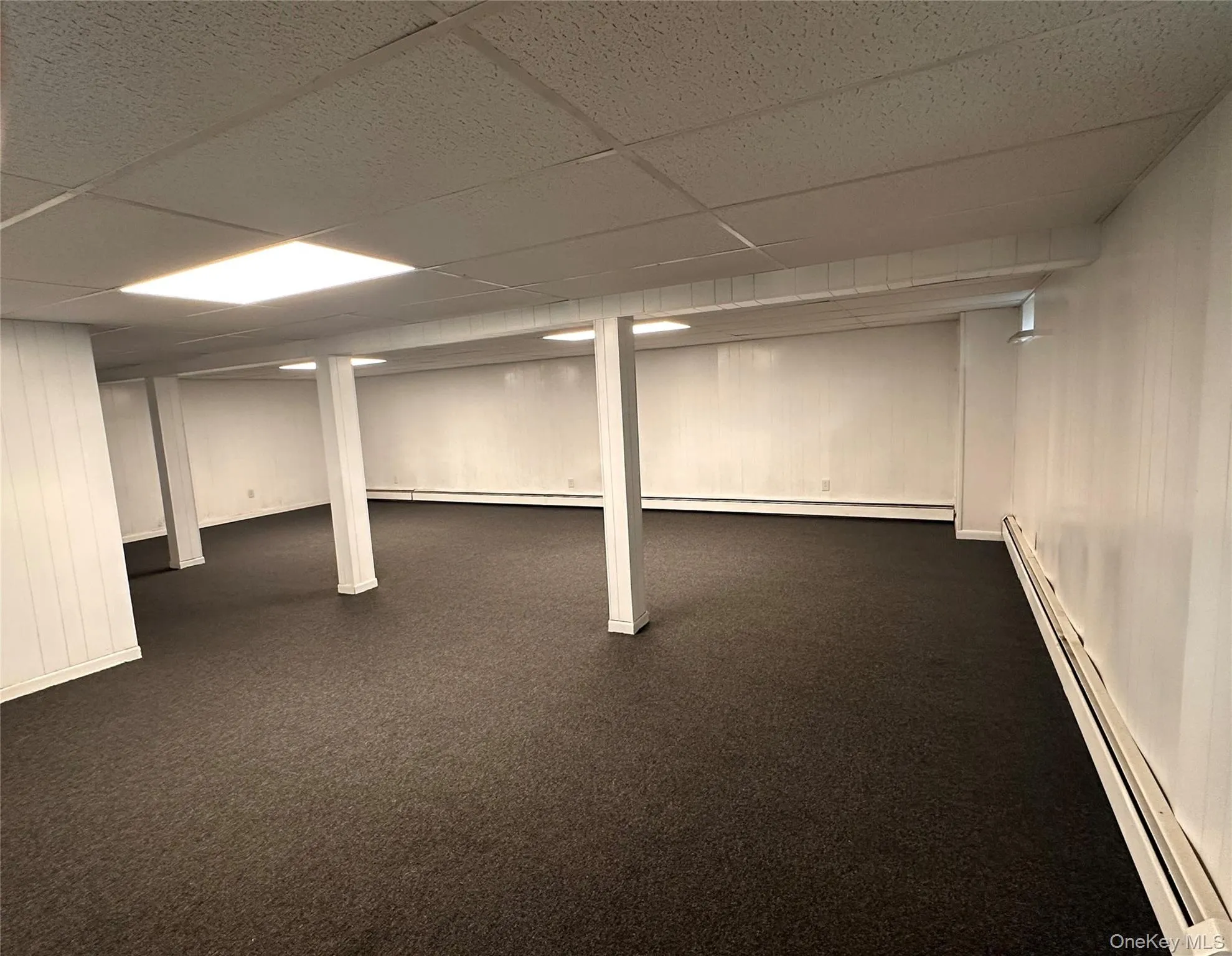 Expansive lower level featuring new carpeting & ceiling tiles, zoned baseboard heating. Expansive lower level featuring new carpeting & ceiling tiles, zoned baseboard heating.