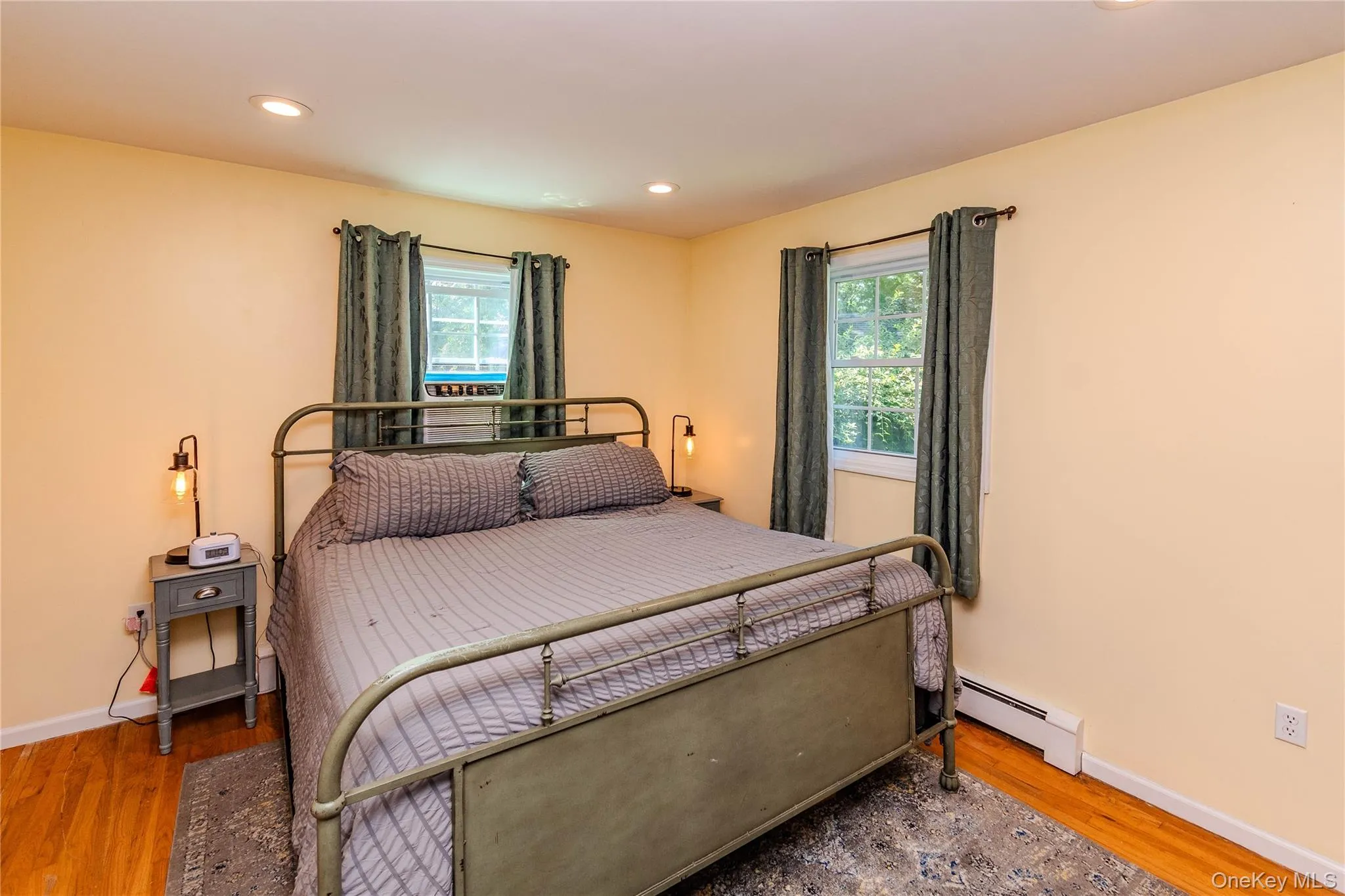 Hardwood flooring, recessed lighting, and two windows with natural light Hardwood flooring, recessed lighting, and two windows with natural light