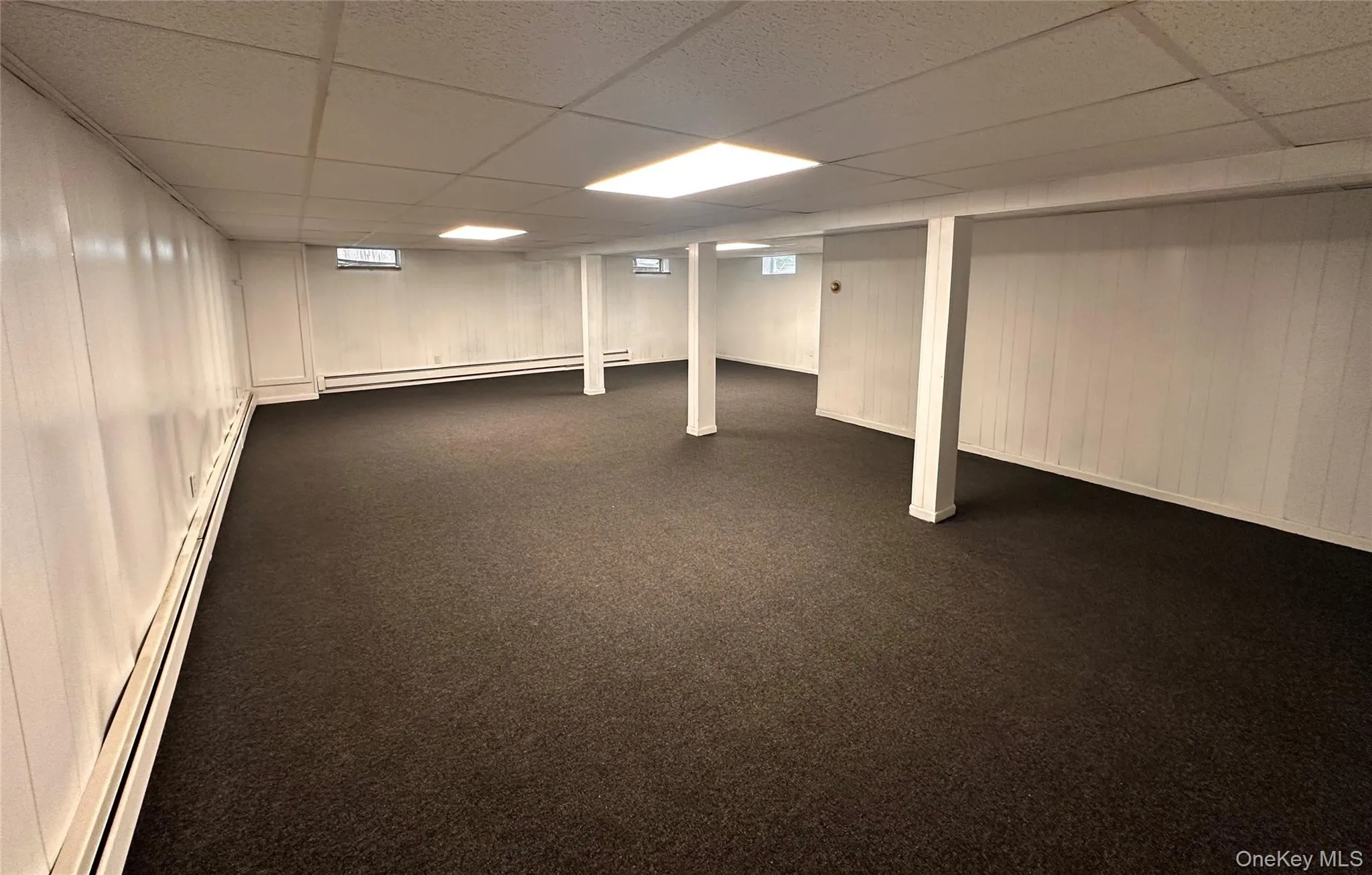 Expansive lower level featuring new carpeting & ceiling tiles, zoned baseboard heating. Expansive lower level featuring new carpeting & ceiling tiles, zoned baseboard heating.