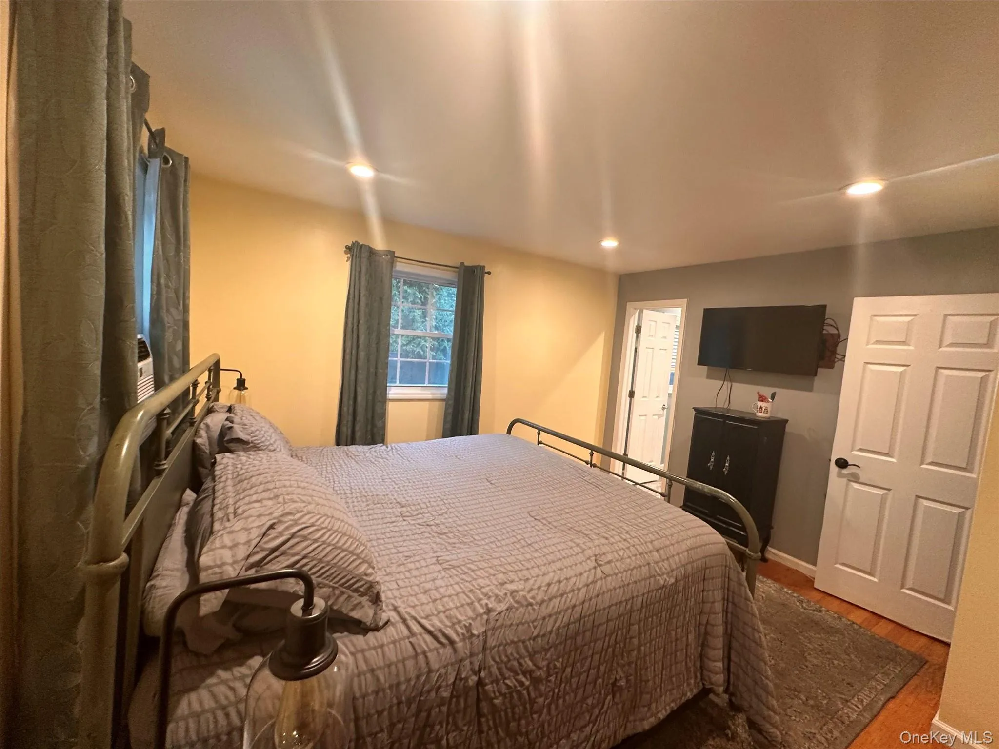 Recessed lighting illuminates this room featuring warm-toned walls Recessed lighting illuminates this room featuring warm-toned walls