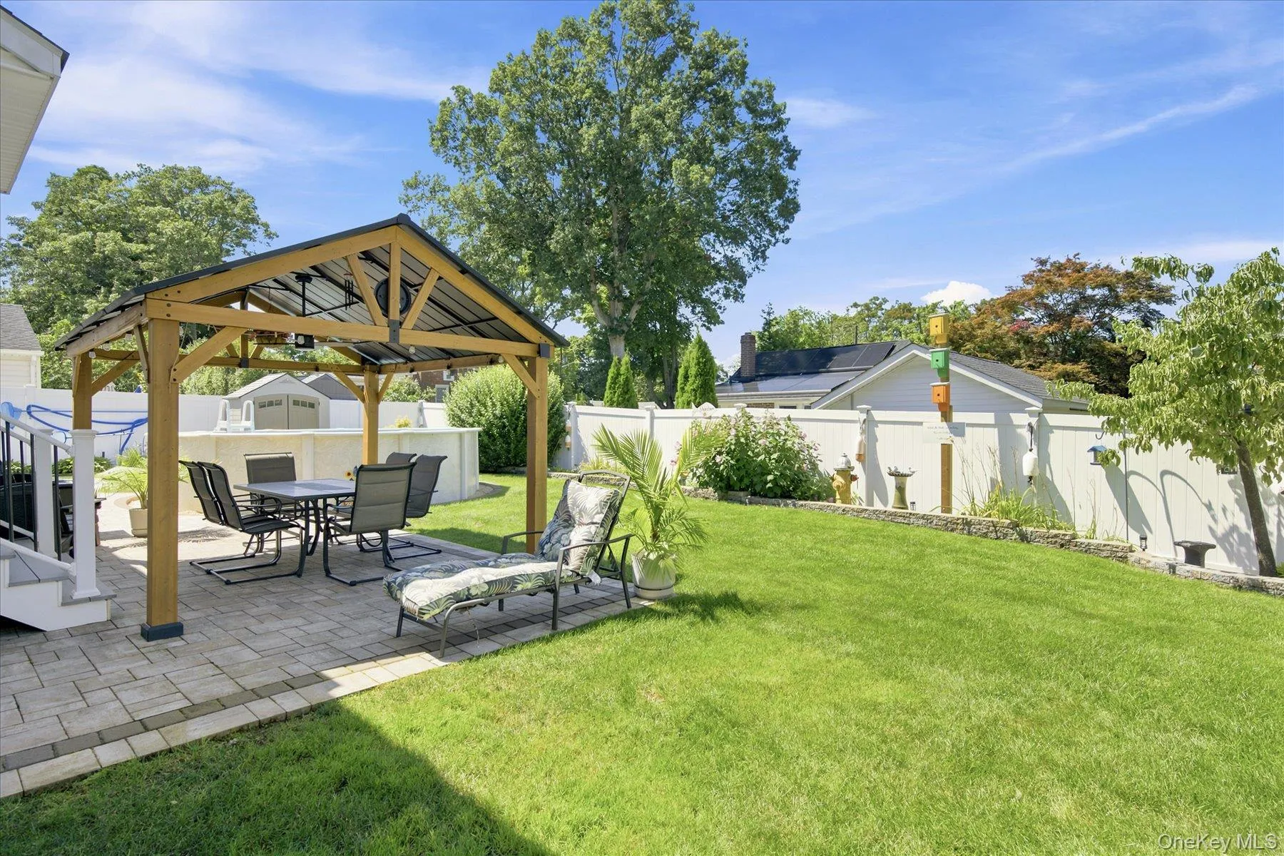 Gorgeous back yard with paver Patio with pergola, new vinyl fencing, back yard fountain and heated above ground pool Gorgeous back yard with paver Patio with pergola, new vinyl fencing, back yard fountain and heated above ground pool