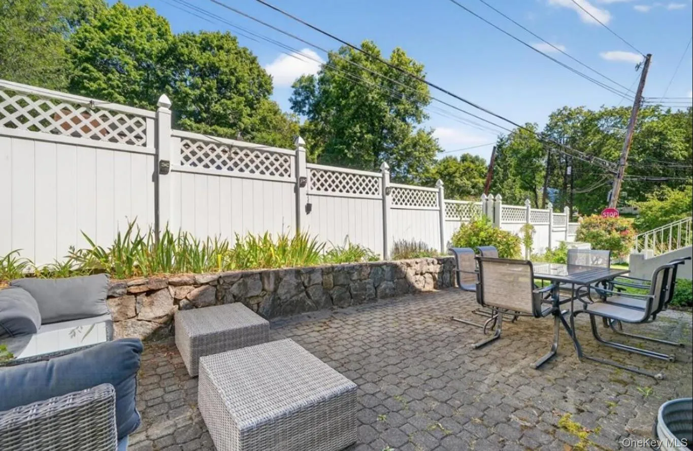 Fenced yard with a patio area, outdoor dining space, and an outdoor living space Fenced yard with a patio area, outdoor dining space, and an outdoor living space