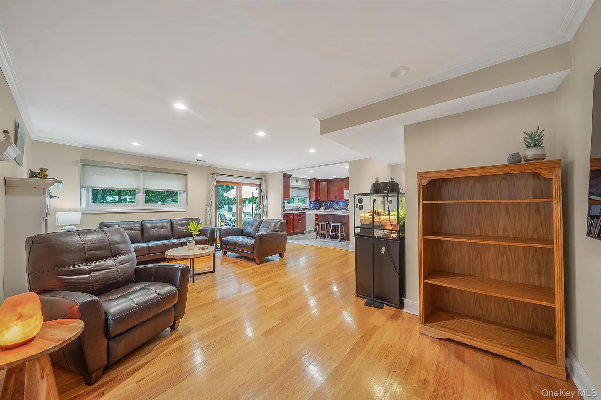 Hardwood flooring throughout the main living space with recessed lighting, crown molding, and light-toned wall paint Hardwood flooring throughout the main living space with recessed lighting, crown molding, and light-toned wall paint