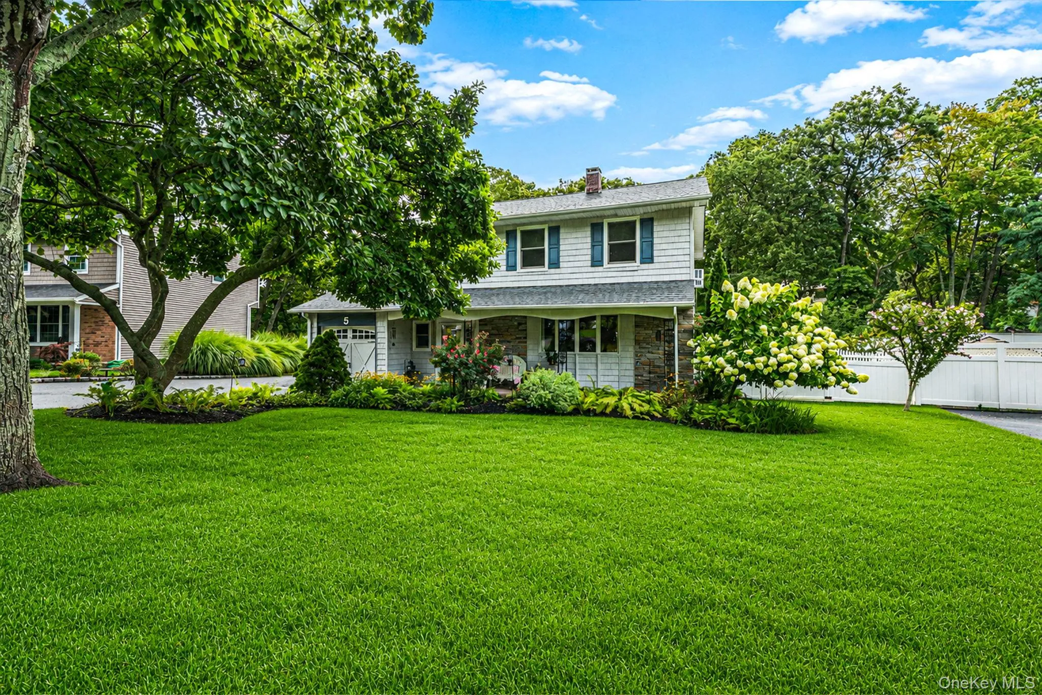 Expansive front lawn with mature trees and established landscaping Expansive front lawn with mature trees and established landscaping