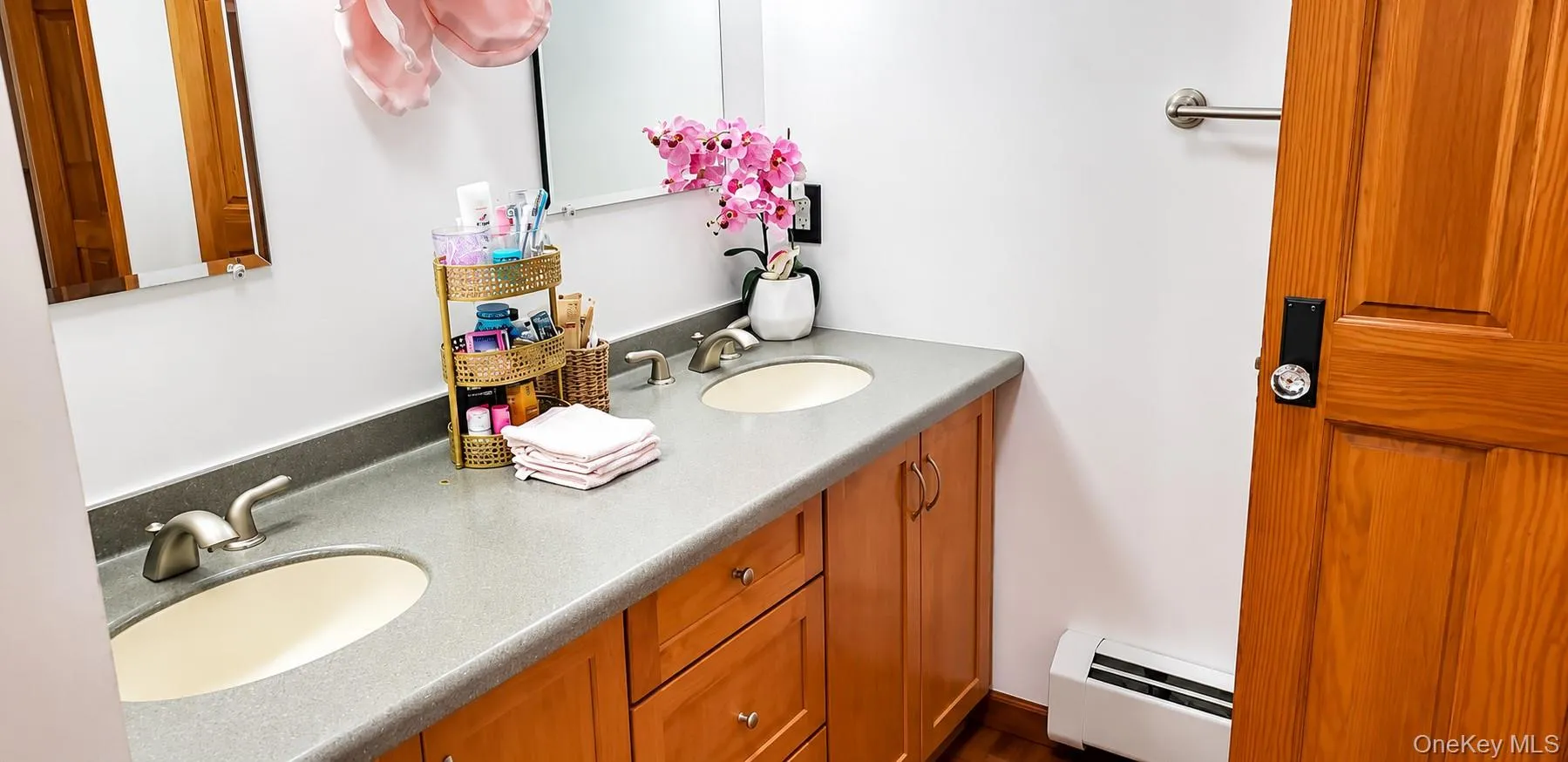 Dual vanity featuring undermount sinks, brushed nickel faucets, and a neutral countertop Dual vanity featuring undermount sinks, brushed nickel faucets, and a neutral countertop