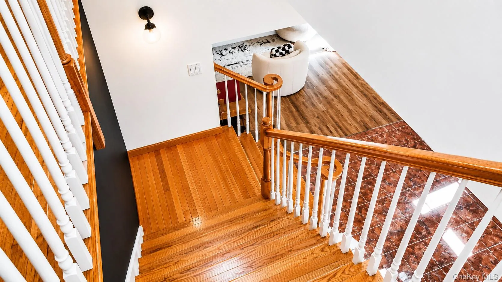 Hardwood staircase with white balusters and wood handrails Hardwood staircase with white balusters and wood handrails