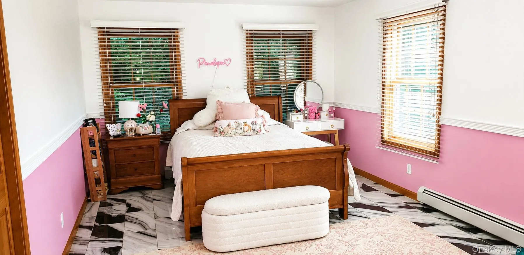 Room featuring wood-finish flooring, three windows with wood-tone blinds, and two-tone wall treatment Room featuring wood-finish flooring, three windows with wood-tone blinds, and two-tone wall treatment