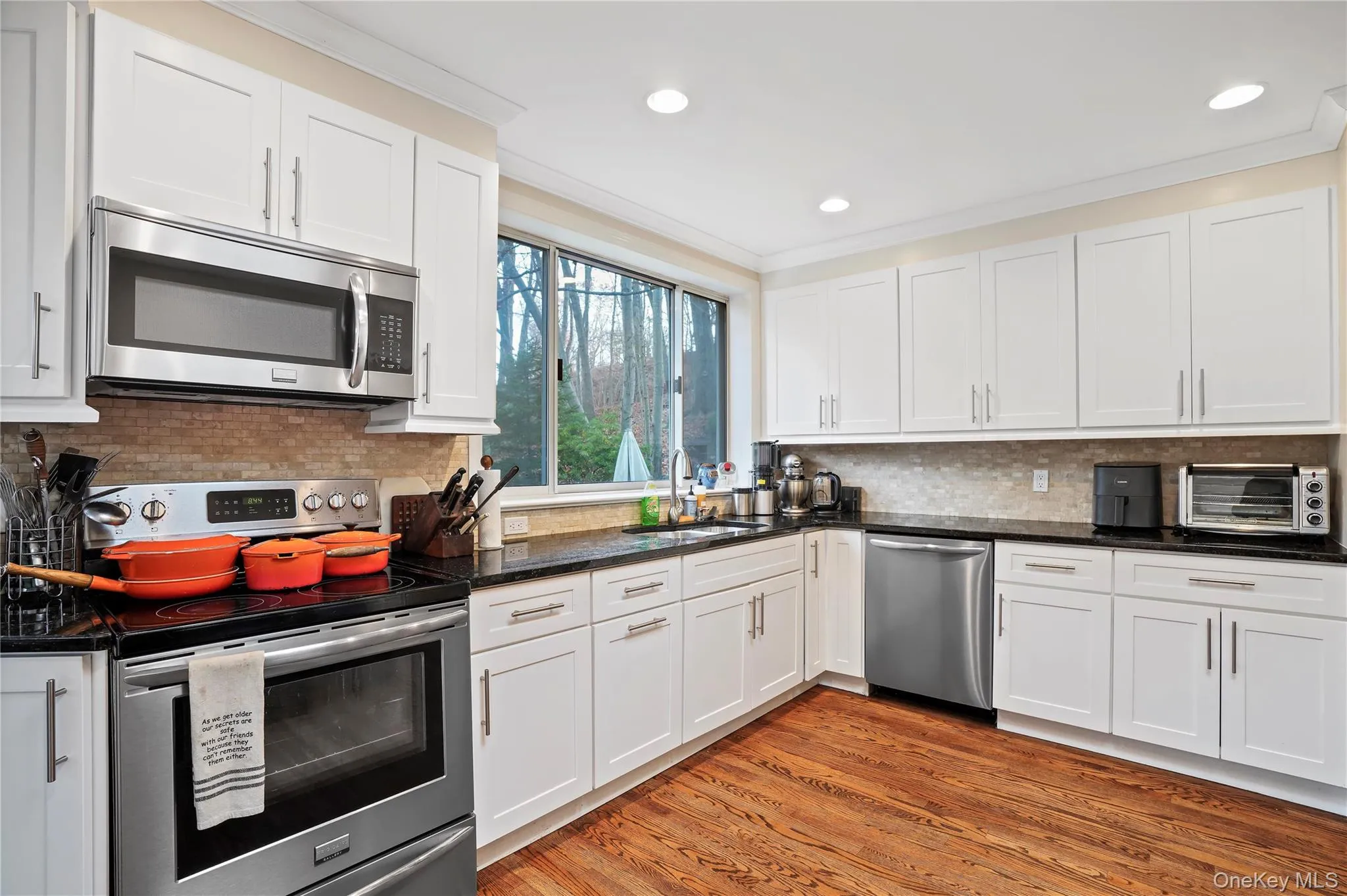 Kitchen Featuring Updated Cabinets, Stainless Steel Appliances, And A Skylight Kitchen Featuring Updated Cabinets, Stainless Steel Appliances, And A Skylight