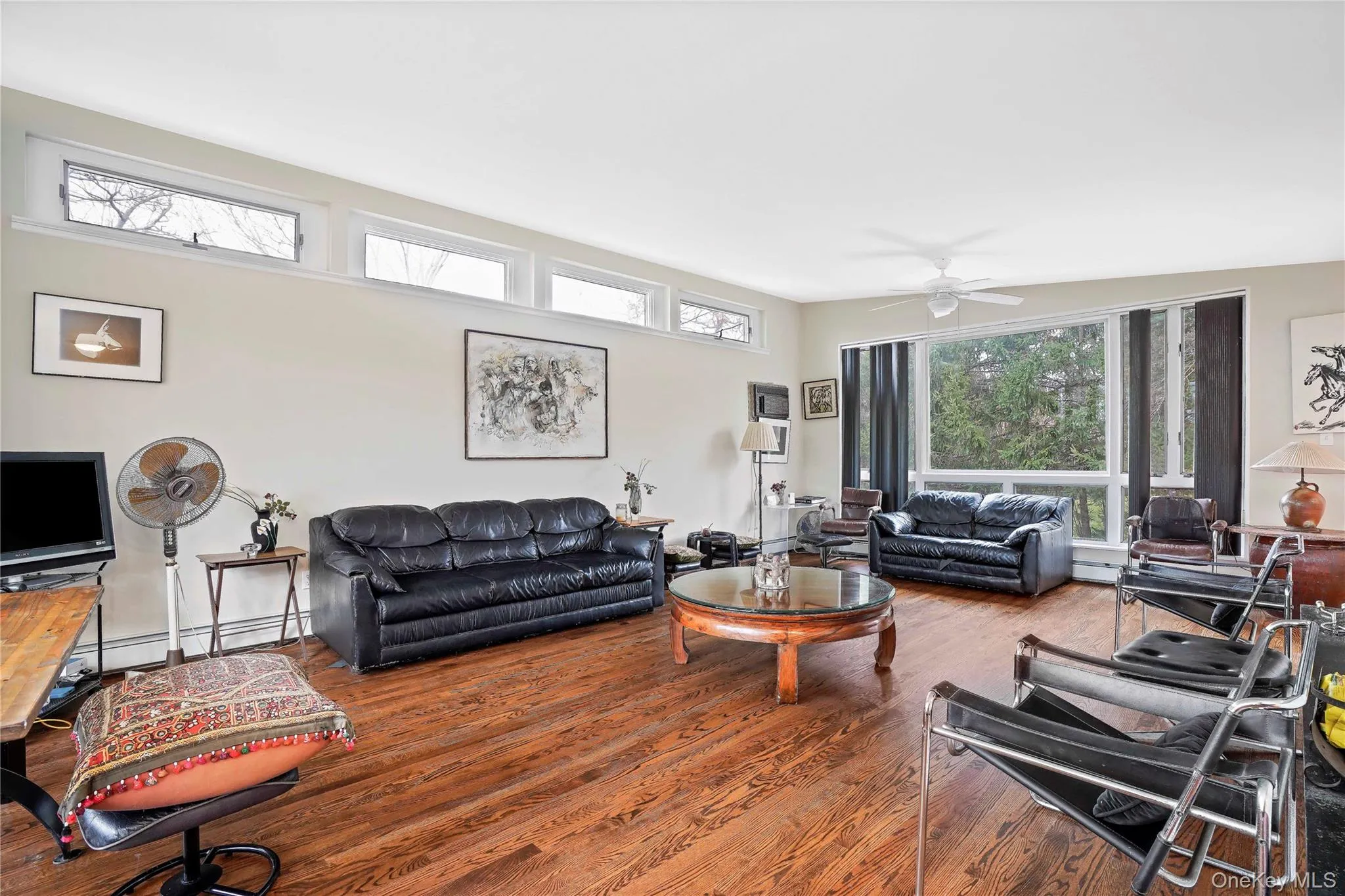 Living Room Featuring Plenty Of Natural Light And Hardwood Floors Living Room Featuring Plenty Of Natural Light And Hardwood Floors
