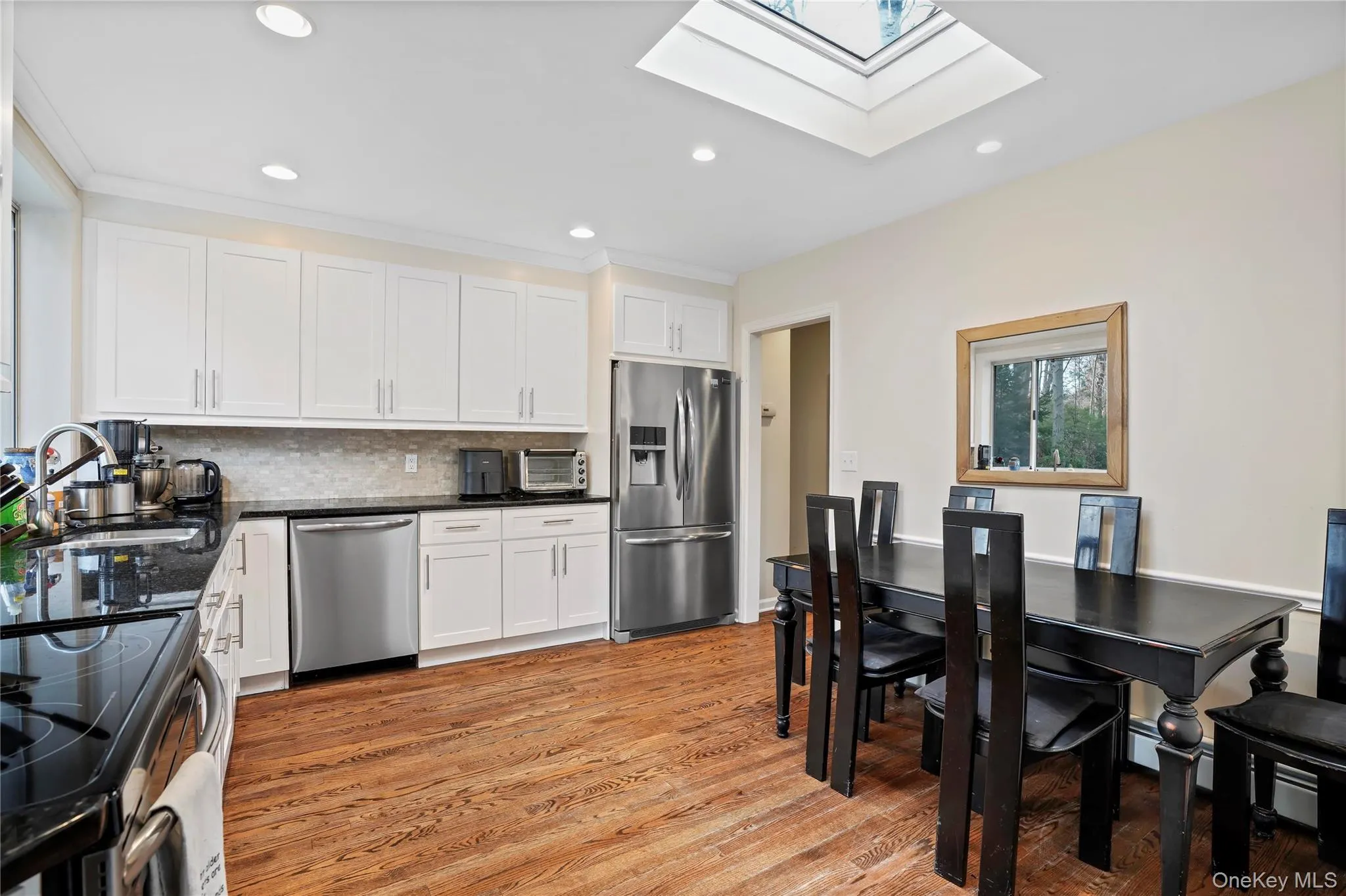 Kitchen Featuring Updated Cabinets, Stainless Steel Appliances, And A Skylight Kitchen Featuring Updated Cabinets, Stainless Steel Appliances, And A Skylight