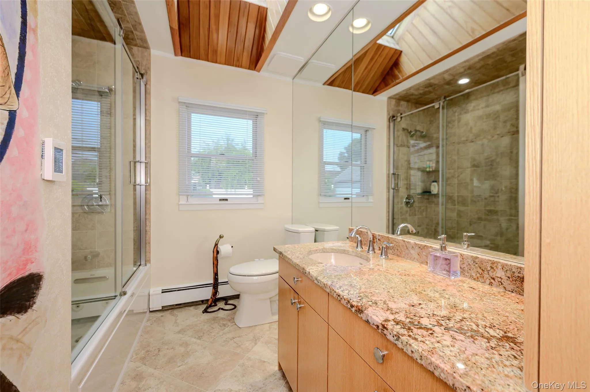 Updated hall bath with Jacuzzi tub & heated flooring Updated hall bath with Jacuzzi tub & heated flooring