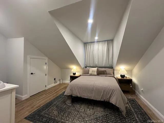 Bedroom featuring wood finished floors Bedroom featuring wood finished floors