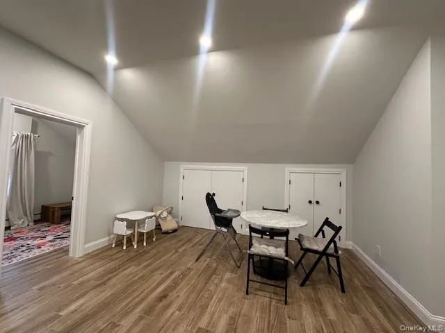 Dining room with wood finished floors and lofted ceiling Dining room with wood finished floors and lofted ceiling