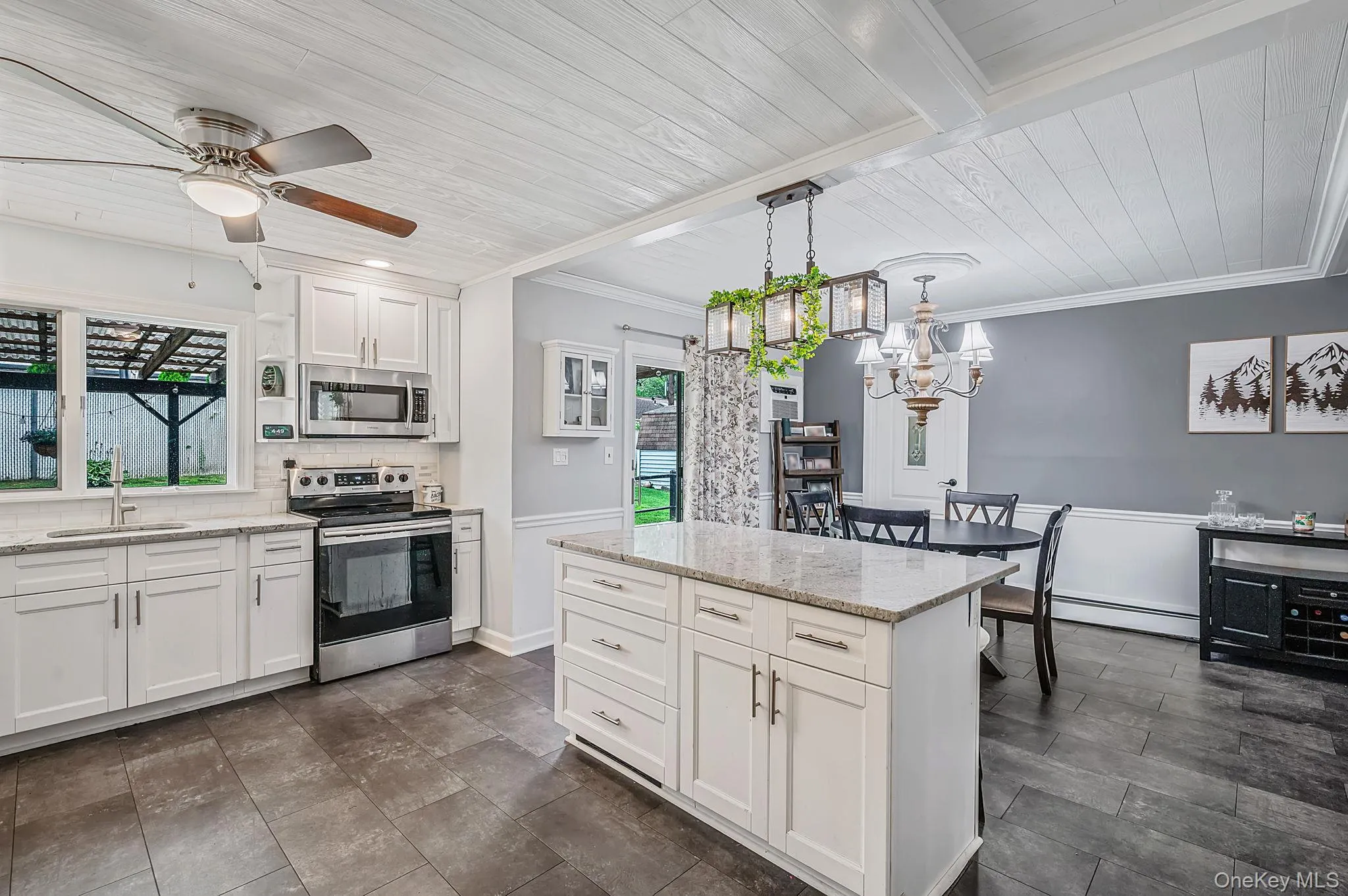 Spacious kitchen featuring white cabinetry, light-toned countertops, and stainless steel appliances Spacious kitchen featuring white cabinetry, light-toned countertops, and stainless steel appliances
