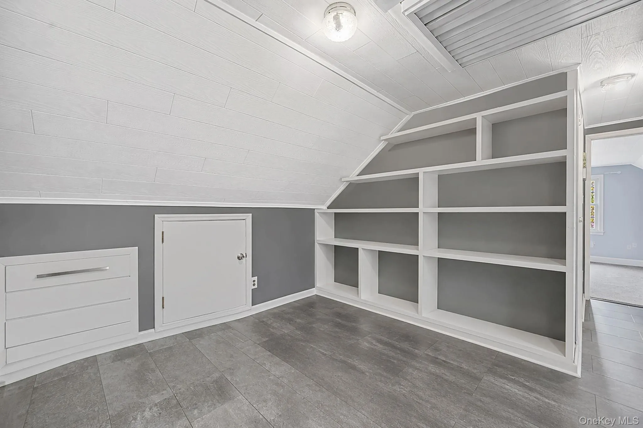 Custom built-in shelving and cabinetry complement the wood-finish flooring Custom built-in shelving and cabinetry complement the wood-finish flooring