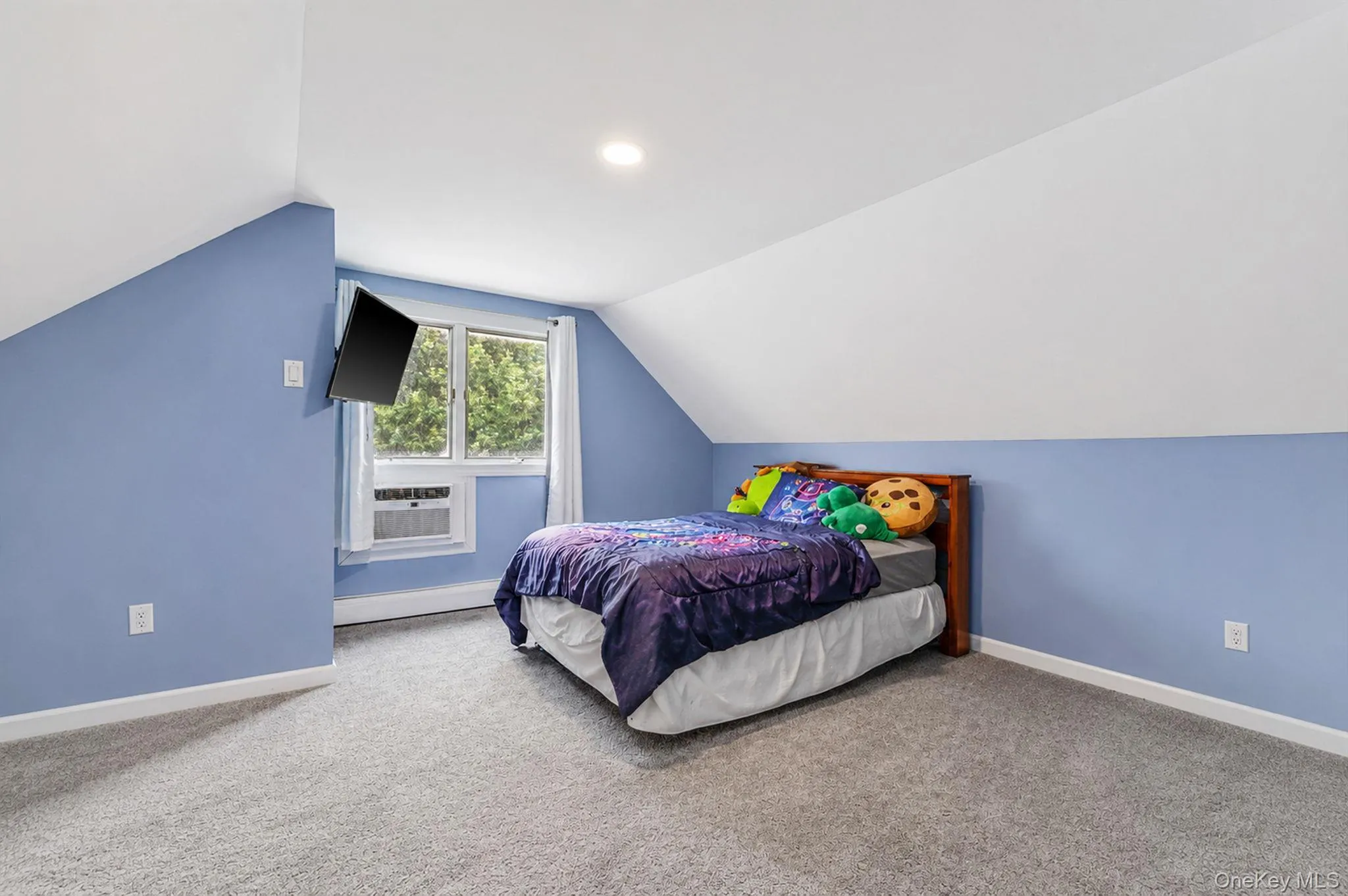 Room with sloped ceilings and light blue walls Room with sloped ceilings and light blue walls