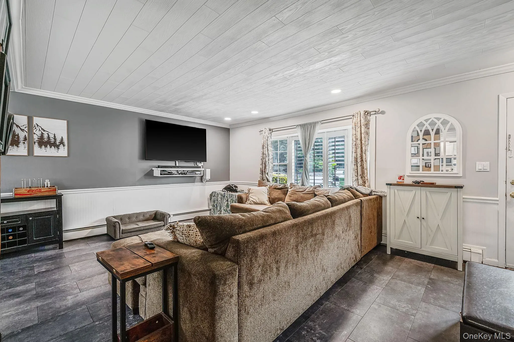 Spacious interior featuring dark-toned flooring, white crown molding, and a paneled ceiling with recessed lighting Spacious interior featuring dark-toned flooring, white crown molding, and a paneled ceiling with recessed lighting