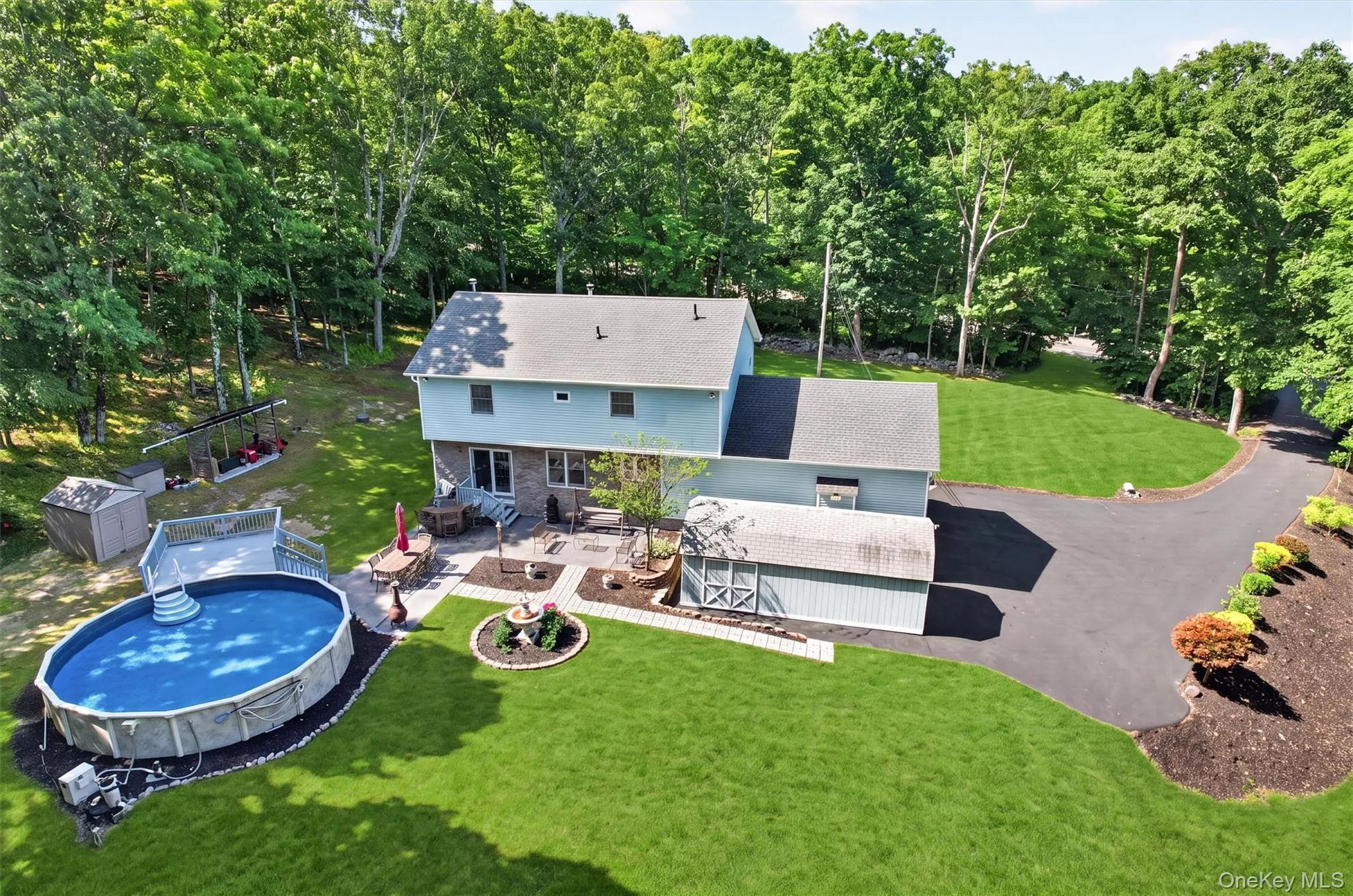 Back of home showing backyard, car barn, and pool. Back of home showing backyard, car barn, and pool.