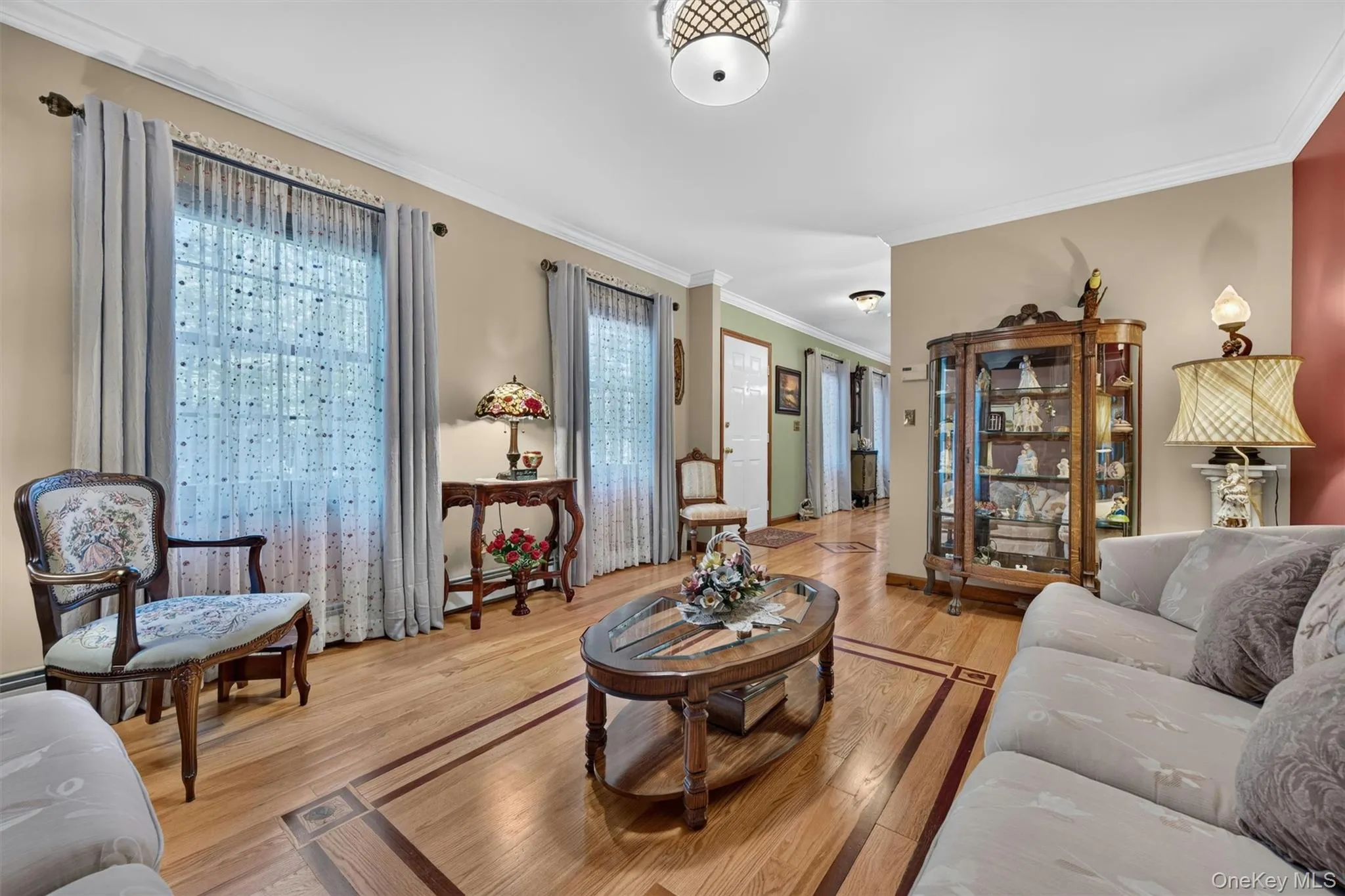 Large windows to front of home in living room. Large windows to front of home in living room.