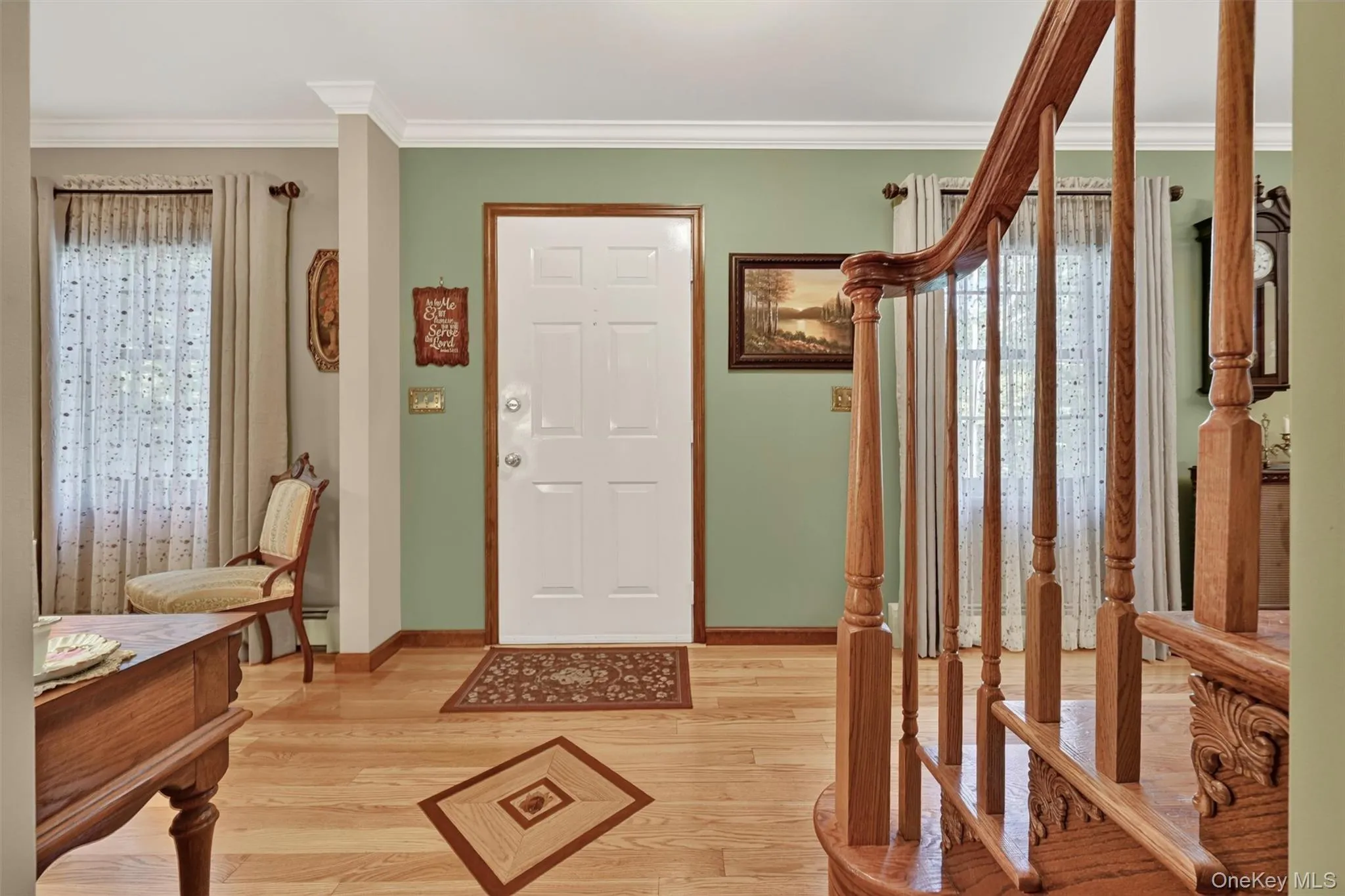 Entrance foyer with beautiful inlaid hardwood floor design and stairs to go up, Entrance foyer with beautiful inlaid hardwood floor design and stairs to go up,