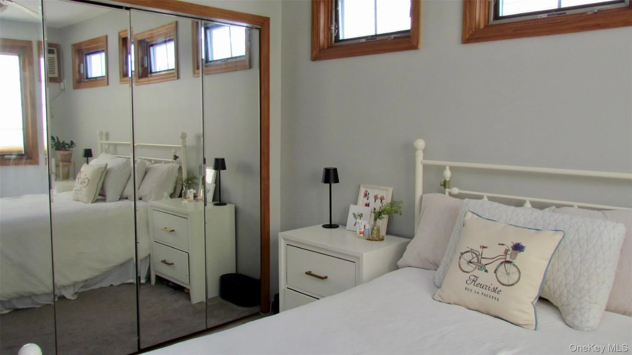 Mirrored closet doors with wood-finish framing Mirrored closet doors with wood-finish framing