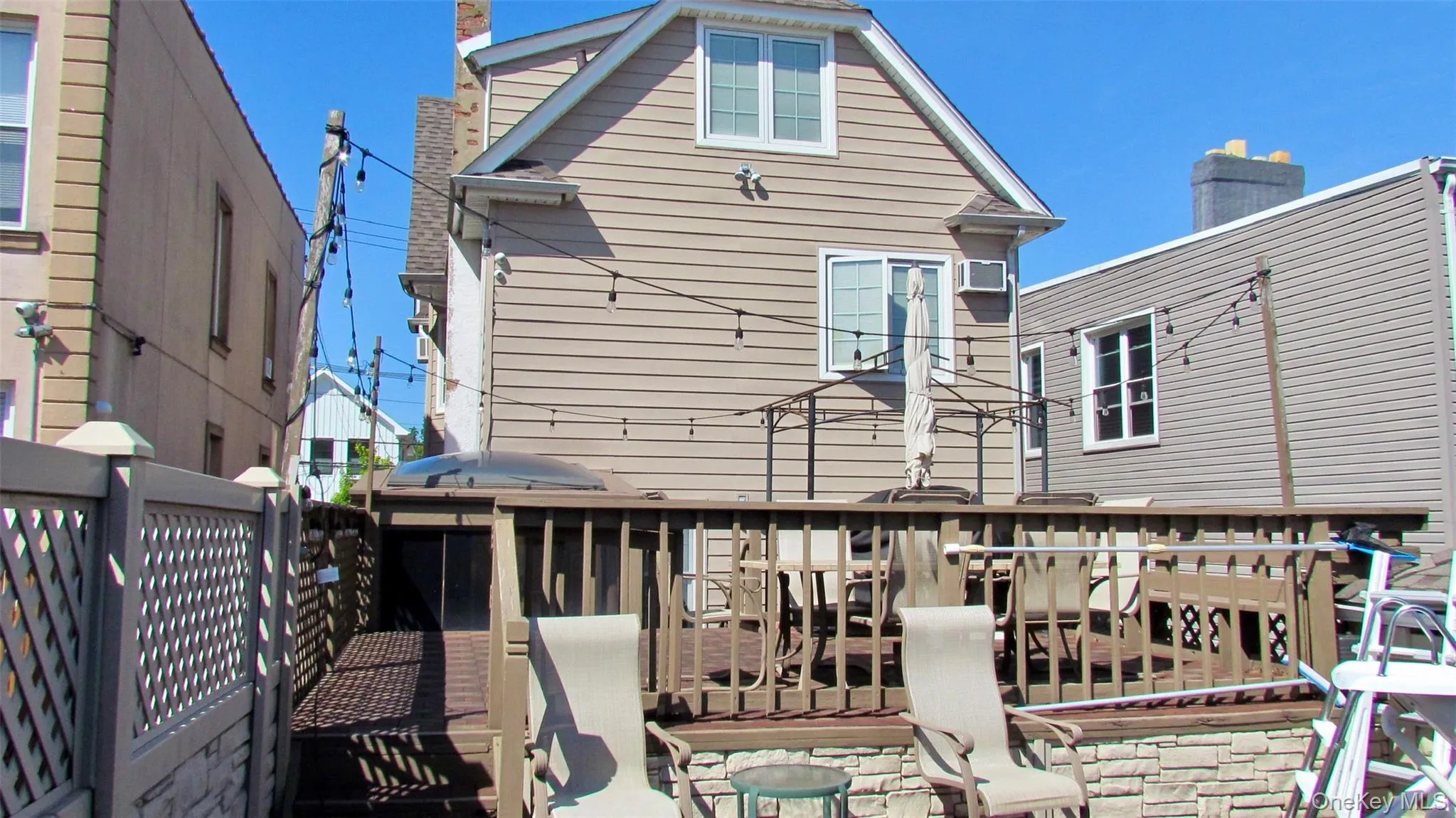 Multi-level exterior deck featuring wood railing and stone veneer accents Multi-level exterior deck featuring wood railing and stone veneer accents
